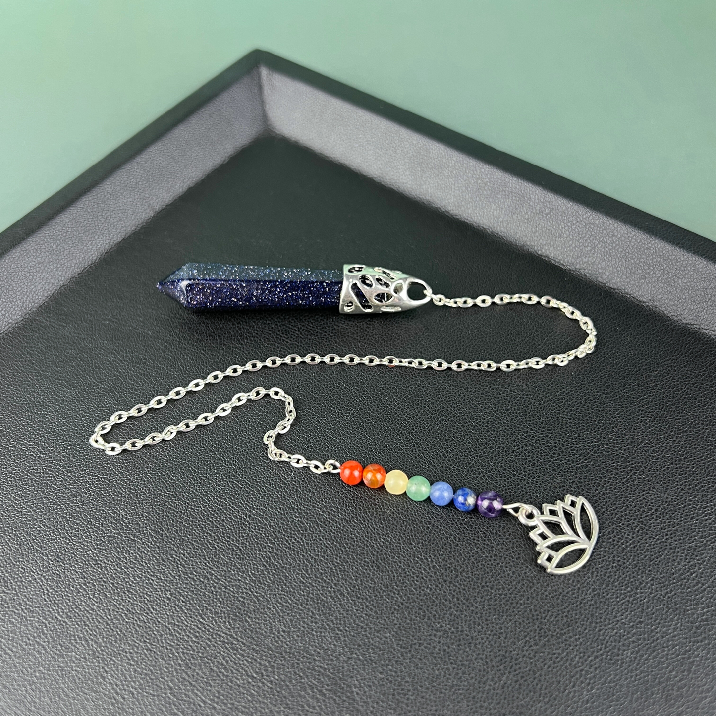 7 chakras blue sandstone pendulum with a lotus charm Baguette Magick