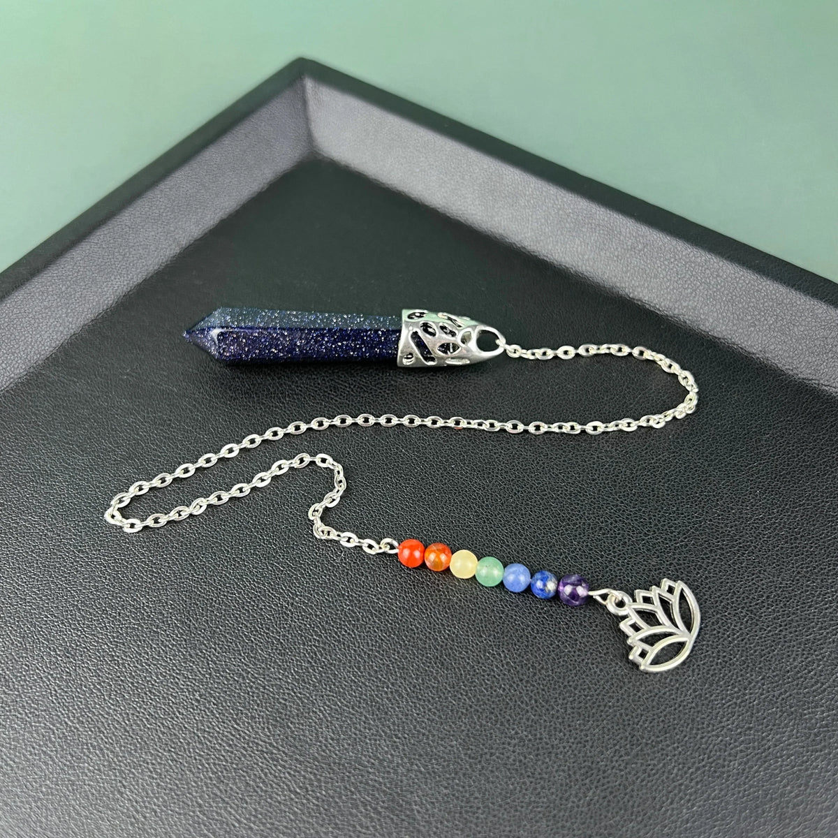 7 chakras blue sandstone pendulum with a lotus charm Baguette Magick