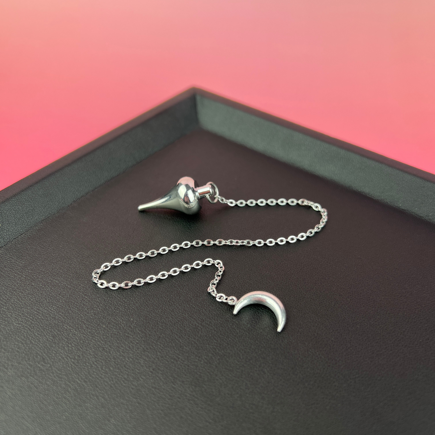 Luzi dowsing metal pendulum with a crescent Moon Baguette Magick