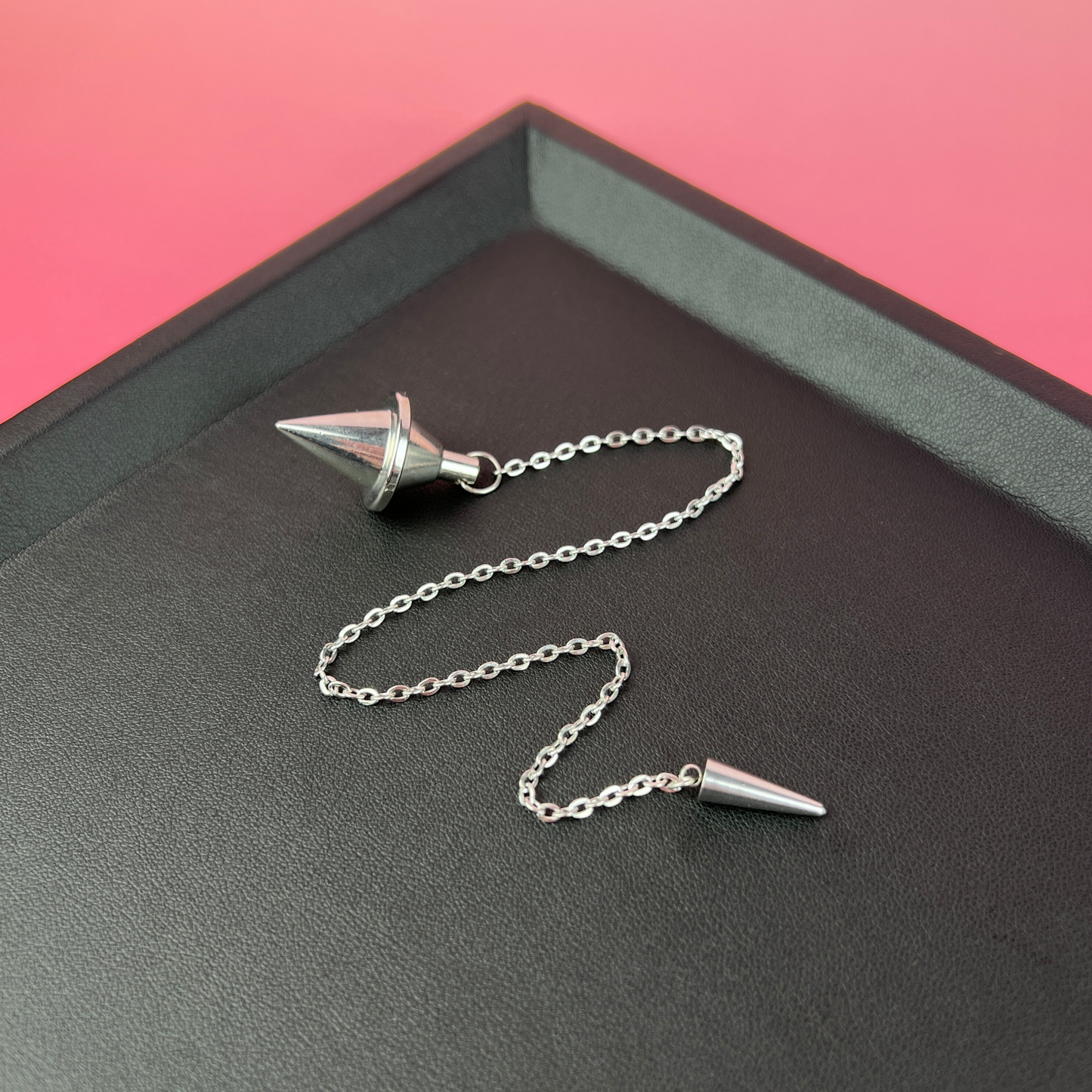 Silver-tone double cone pendulum with a spike charm Baguette Magick