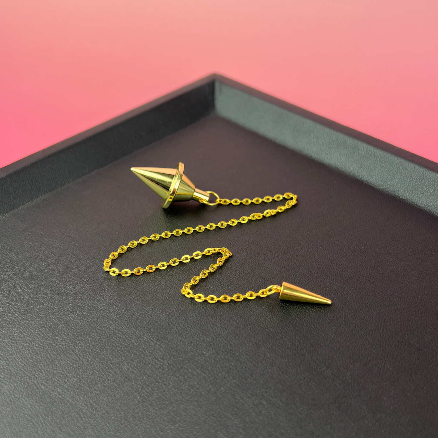 Golden double cone pendulum with a spike charm Baguette Magick
