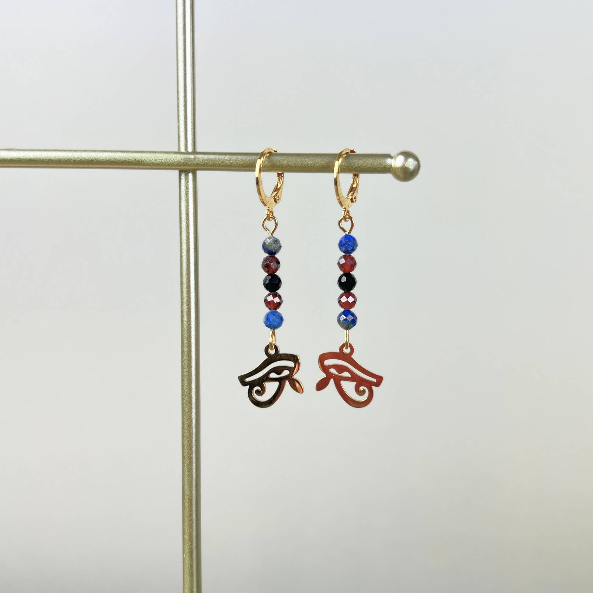 Golden Eye of Horus earrings, lapis lazuli, garnet and onyx Baguette Magick