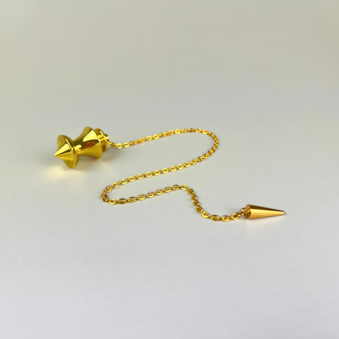 Golden point and dome dowsing metal pendulum with a spike charm Baguette Magick