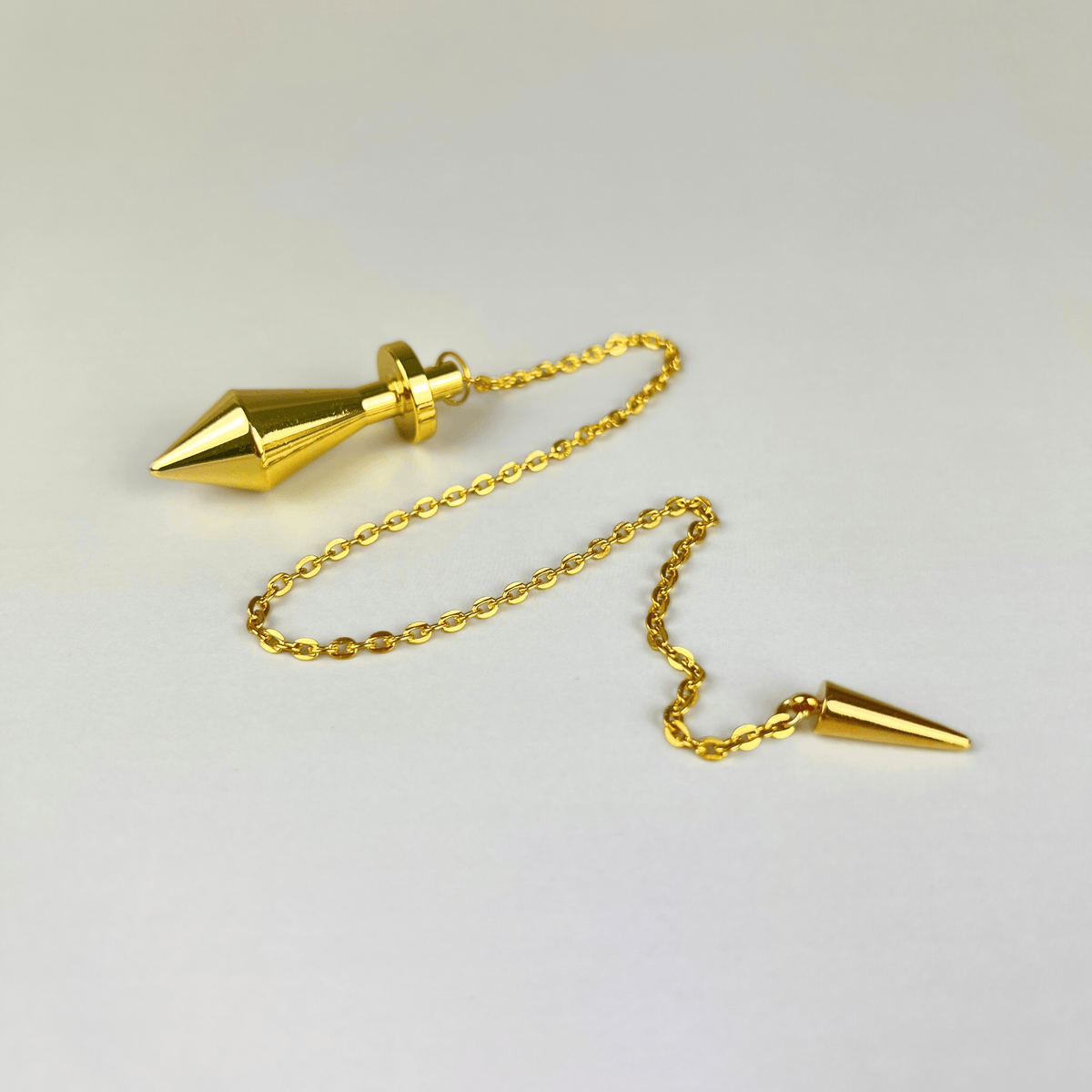 Golden long point dowsing metal pendulum with a spike charm Baguette Magick