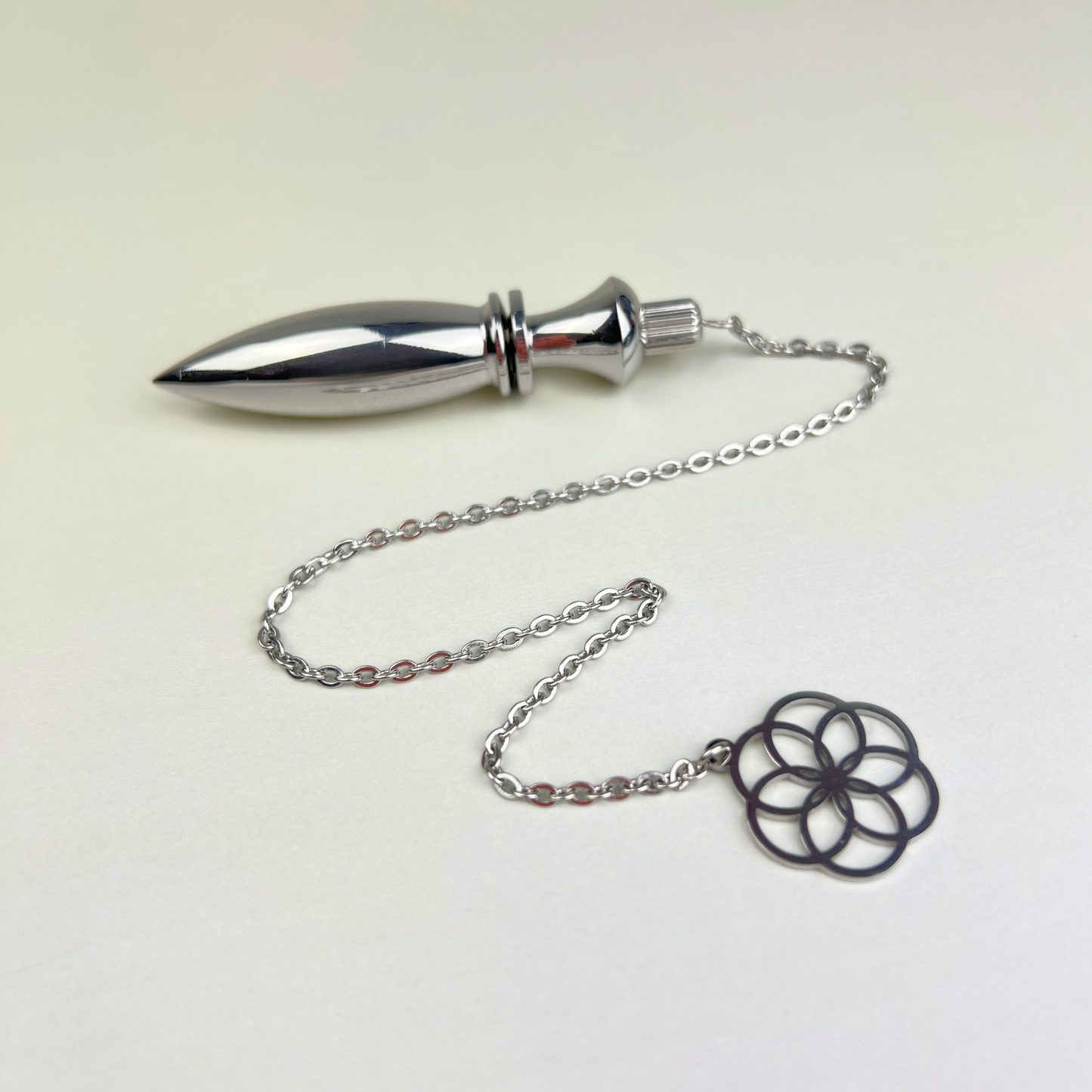 Metal Thot pendulum with a flower of life symbol Baguette Magick