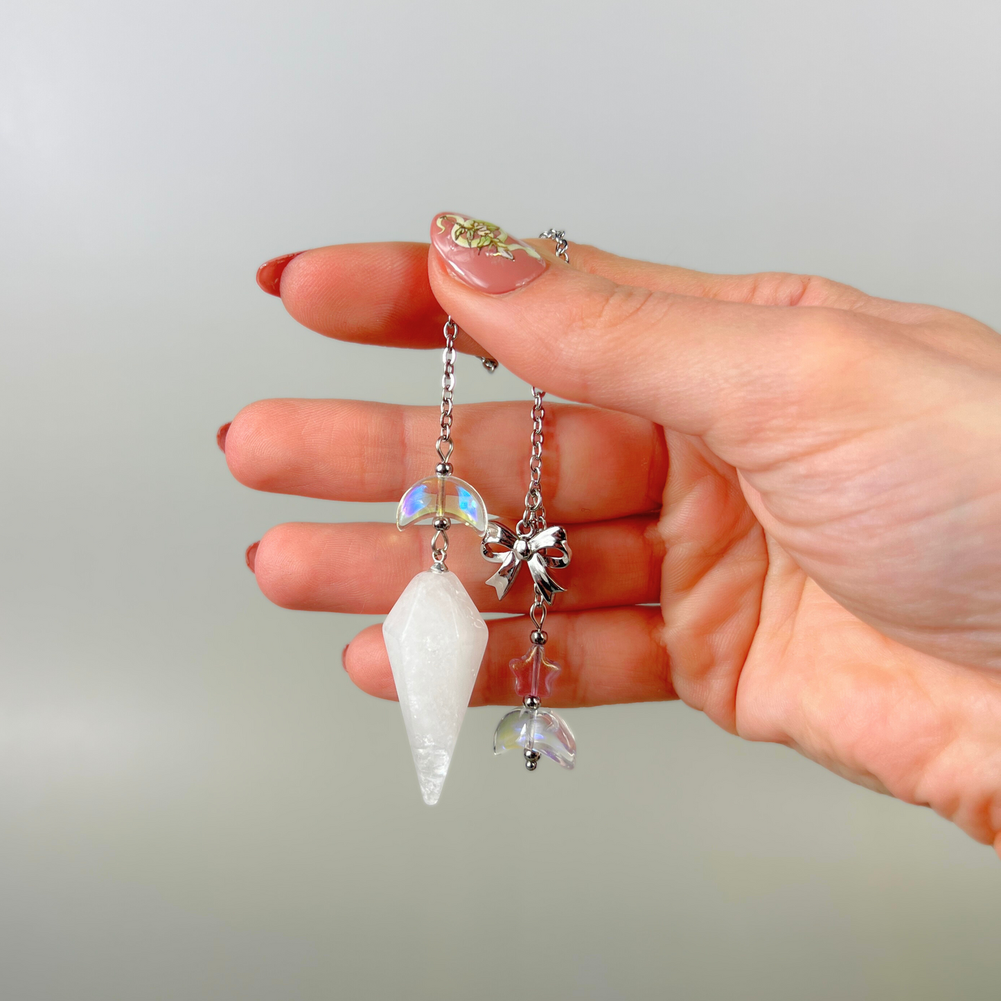Celestial Clear Quartz dowsing pendulum, with moon, star & bow charms