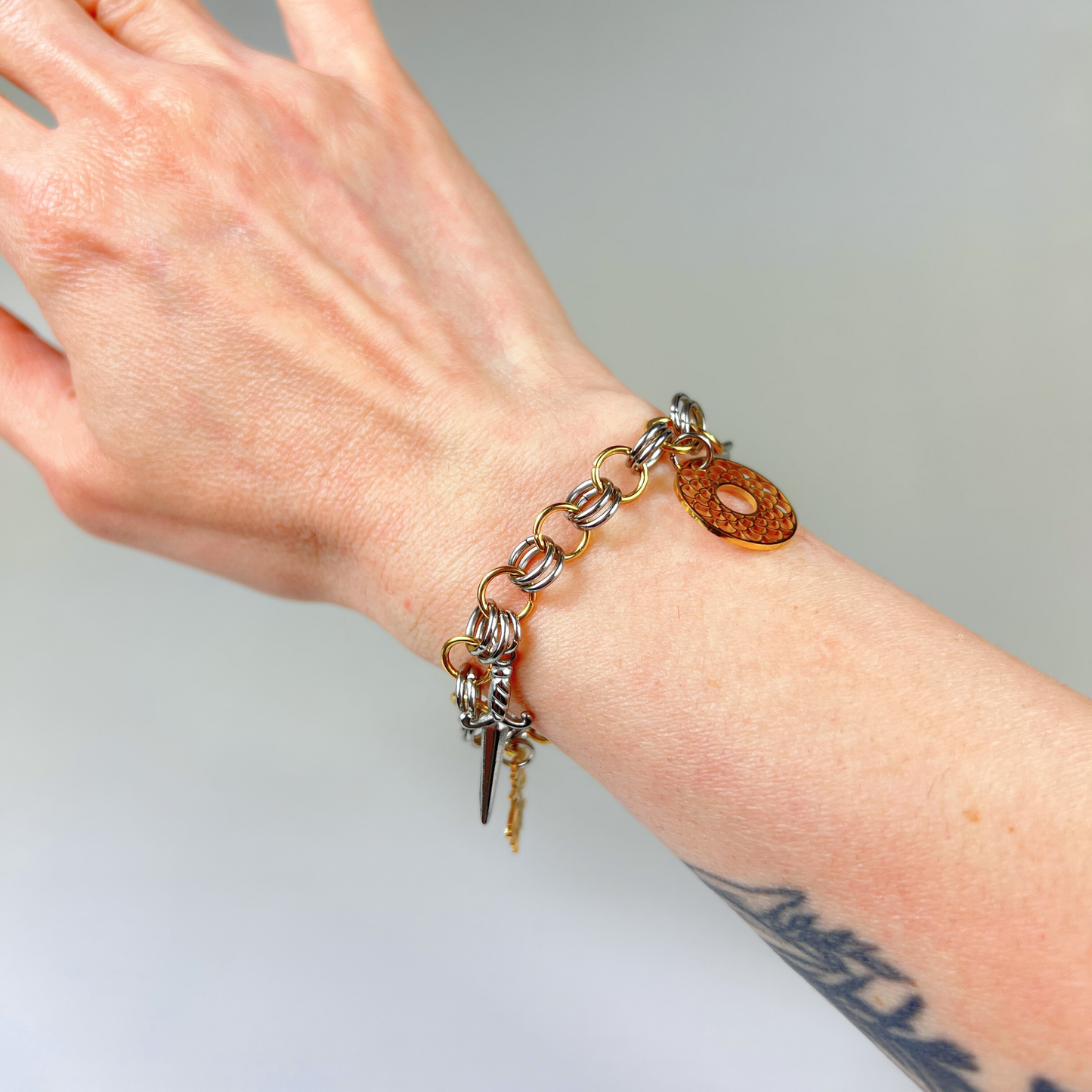 Chainmail charm bracelet, gold and silver tones
