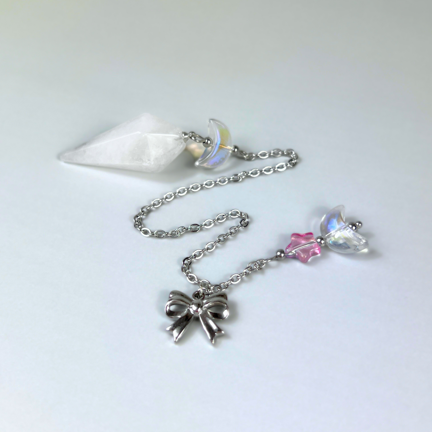Celestial Clear Quartz dowsing pendulum, with moon, star & bow charms