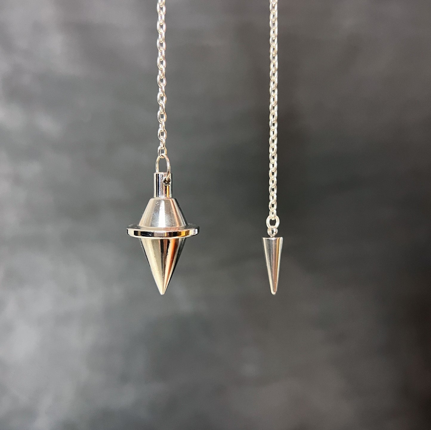 Silver-tone double cone pendulum with a spike charm Baguette Magick