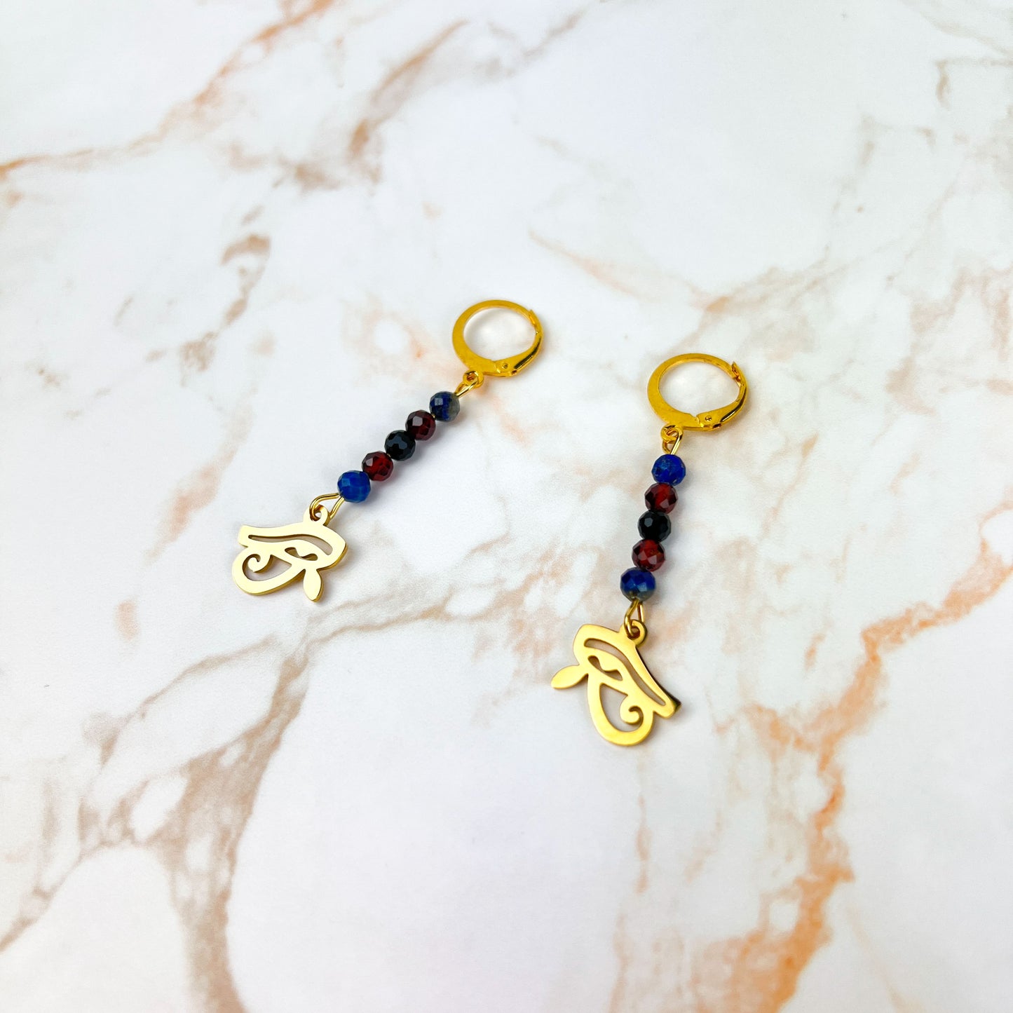 Eye of Horus earrings, golden stainless steel, lapis lazuli, garnet and onyx Baguette Magick