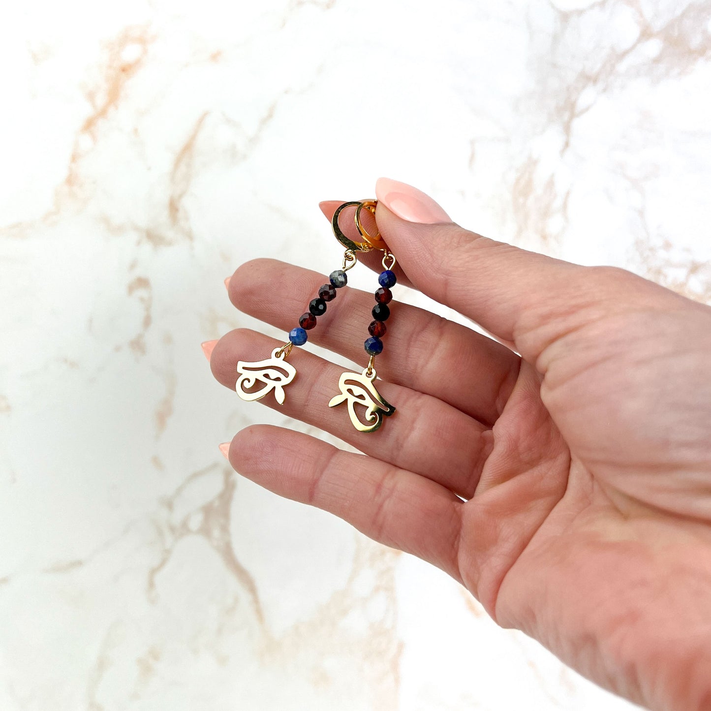 Eye of Horus earrings, golden stainless steel, lapis lazuli, garnet and onyx Baguette Magick