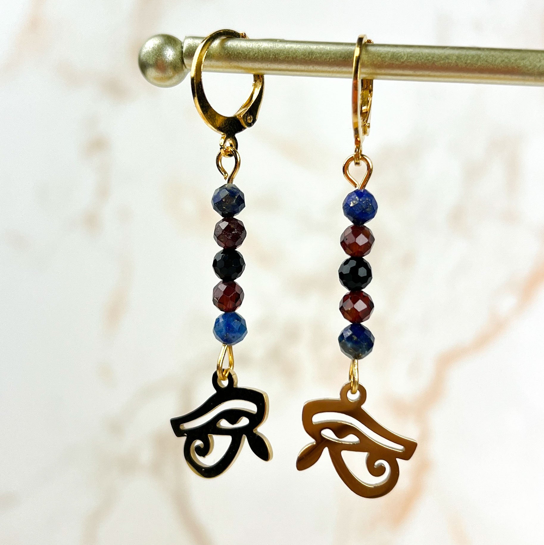 Eye of Horus earrings, golden stainless steel, lapis lazuli, garnet and onyx Baguette Magick