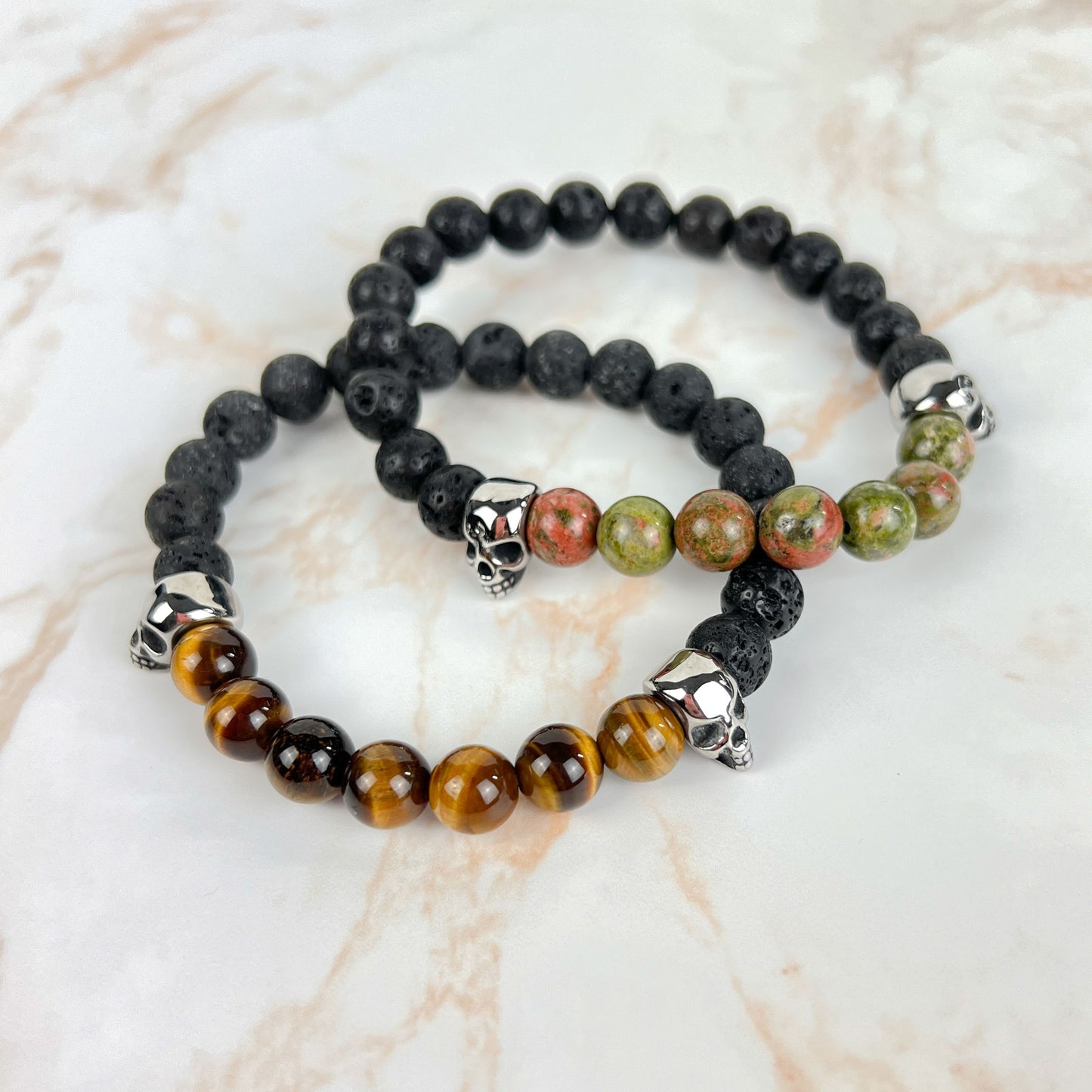 Lava rock and unakite or tiger's eye mala bracelet, with stainless steel skulls Baguette Magick