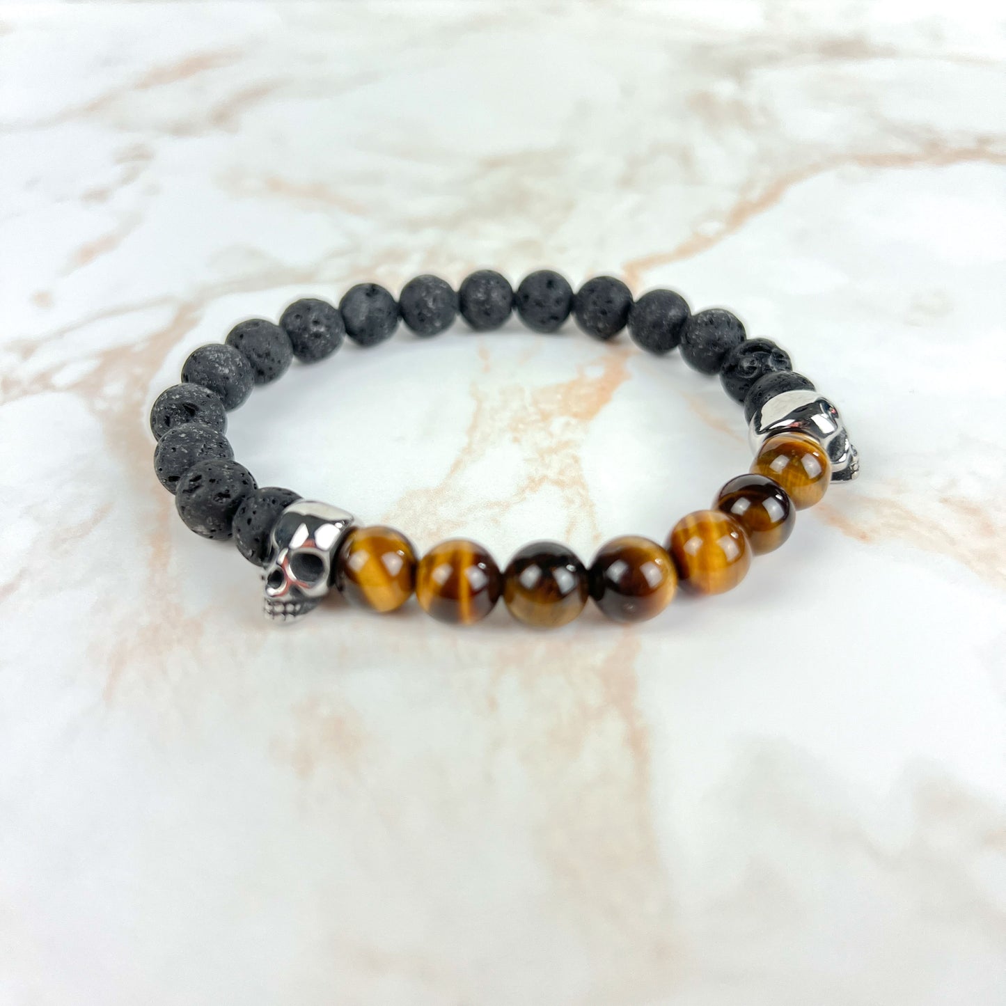 Lava rock and unakite or tiger's eye mala bracelet, with stainless steel skulls Baguette Magick