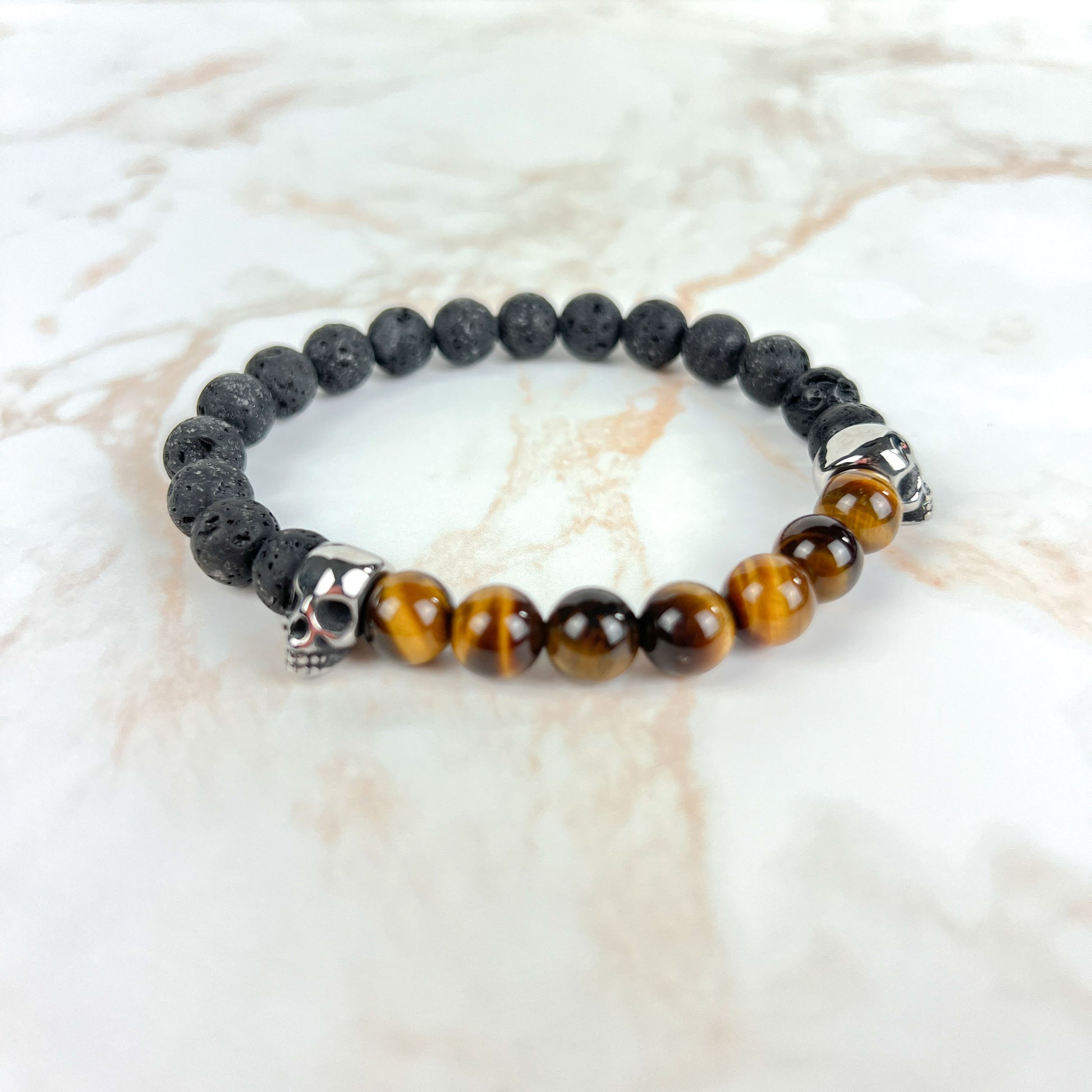Lava rock and unakite or tiger's eye mala bracelet, with stainless steel skulls Baguette Magick