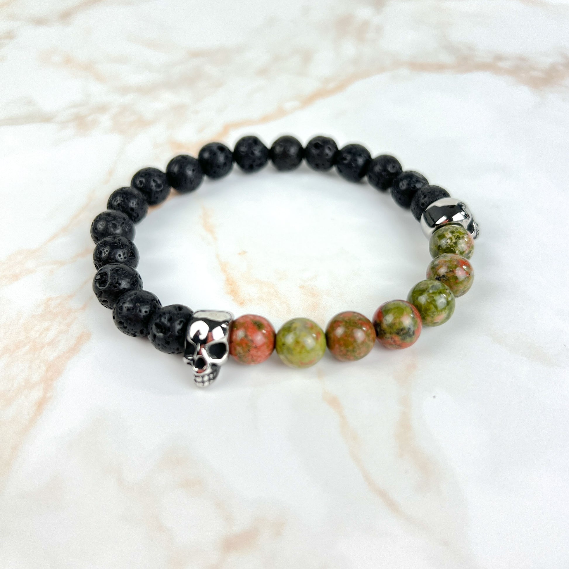 Lava rock and unakite or tiger's eye mala bracelet, with stainless steel skulls Baguette Magick