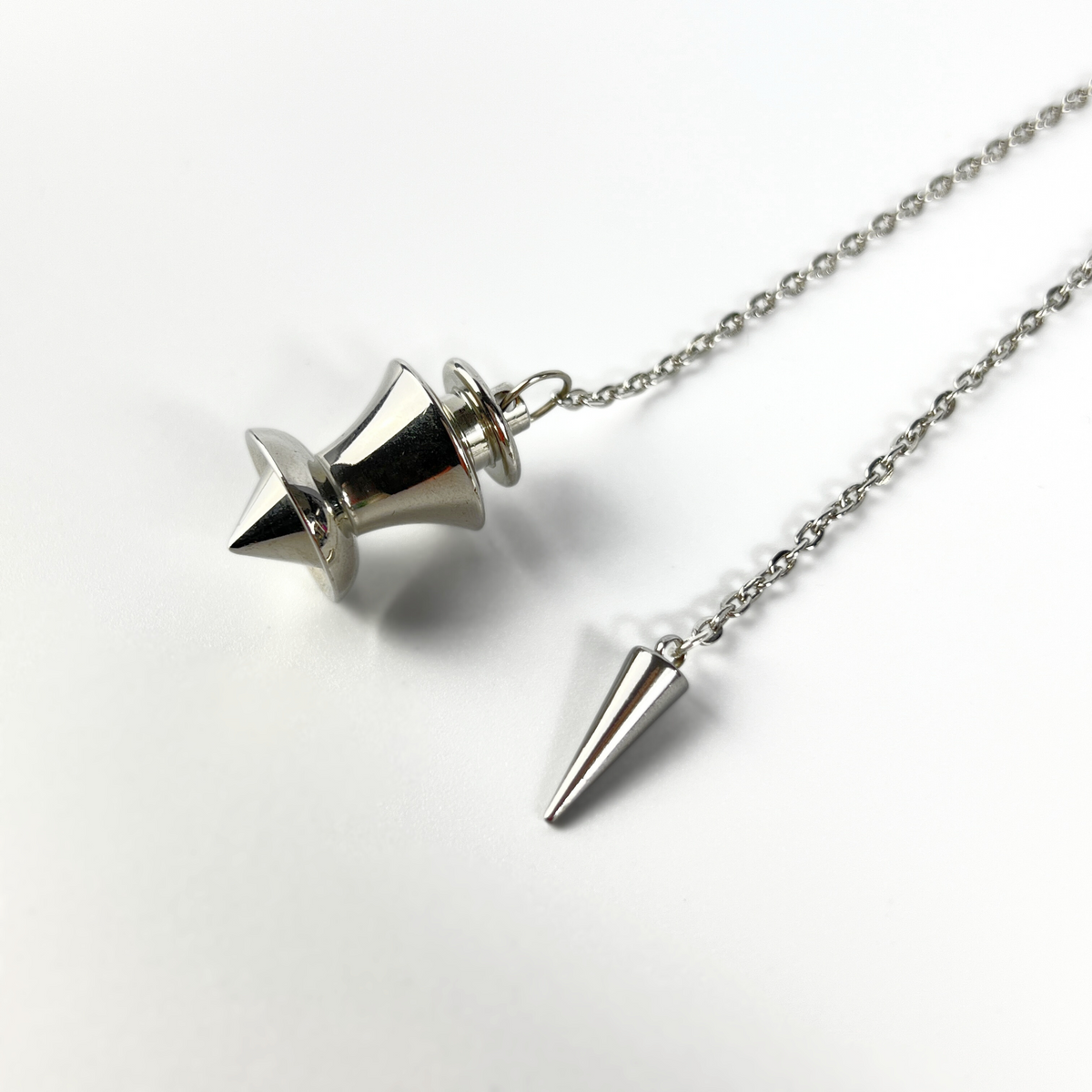 Point and dome dowsing metal pendulum with a spike charm