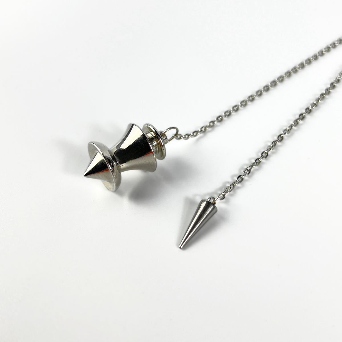 Point and dome dowsing metal pendulum with a spike charm