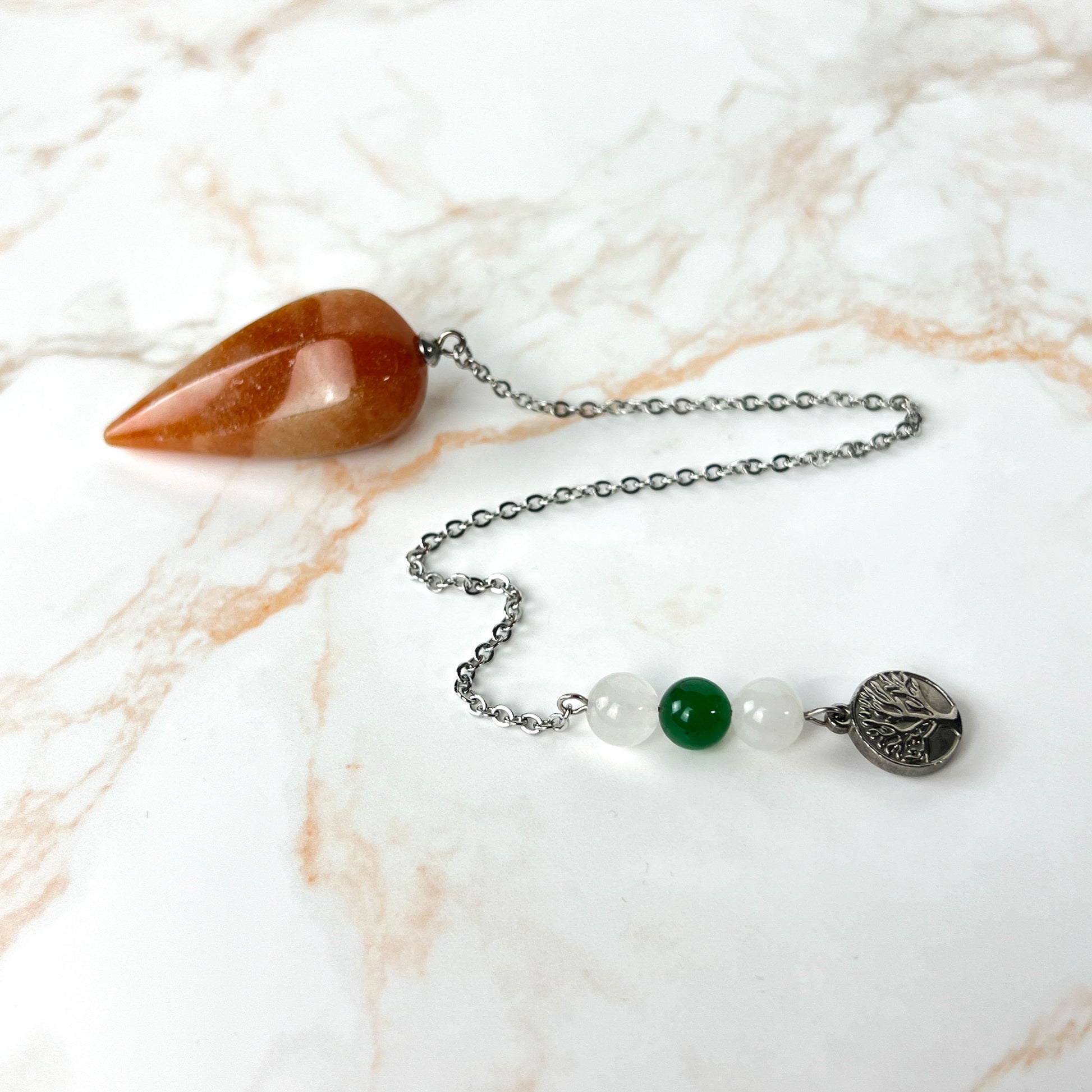 Orange and green aventurine, clear quartz, and tree of life stainless steel pendulum Baguette Magick