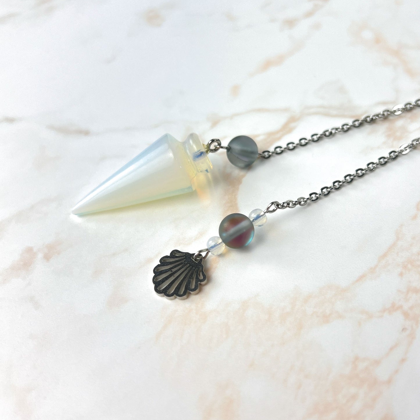 Sea witch pendulum made with opalite, stainless steel and mermaid glass Baguette Magick