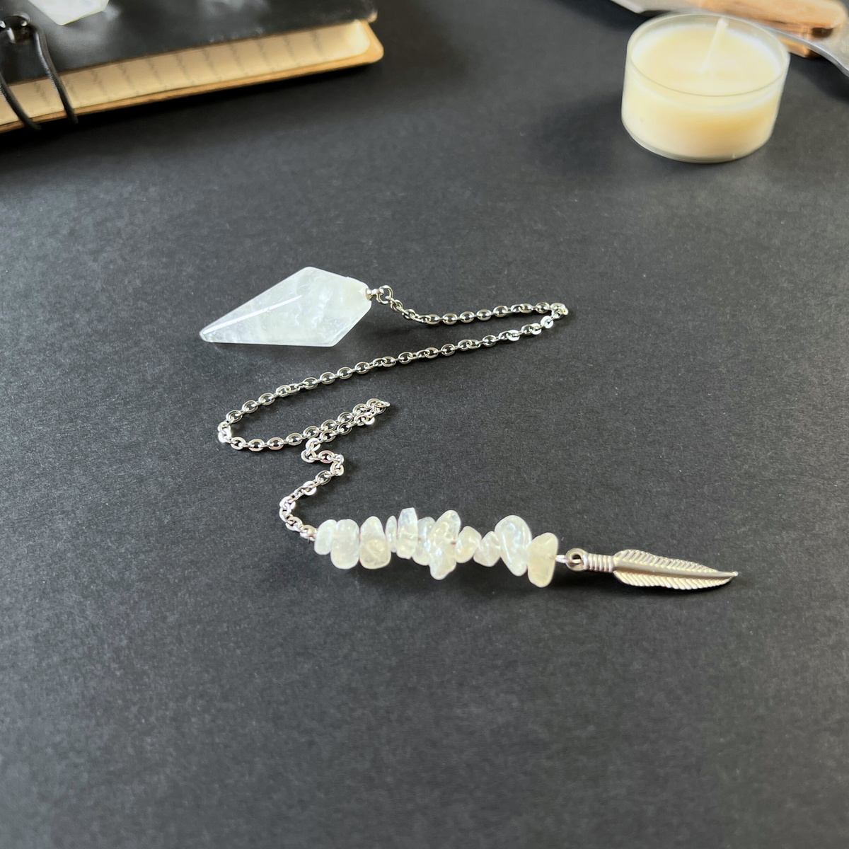 Clear quartz and feather pendulum