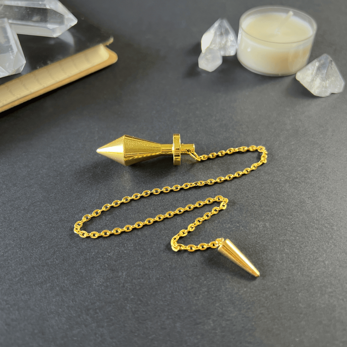 Golden long point dowsing metal pendulum with a spike charm