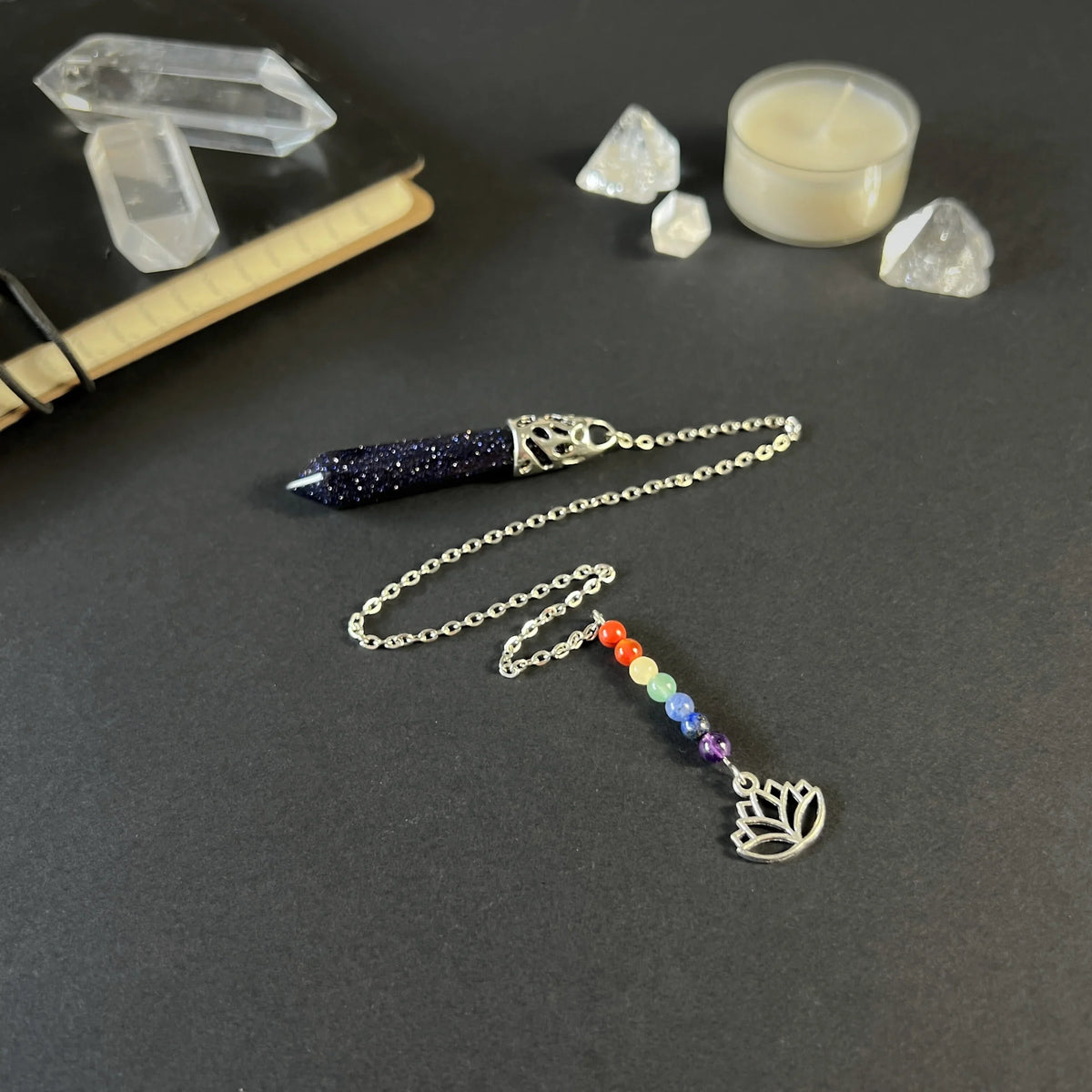 7 chakras blue sandstone pendulum with a lotus charm Baguette Magick
