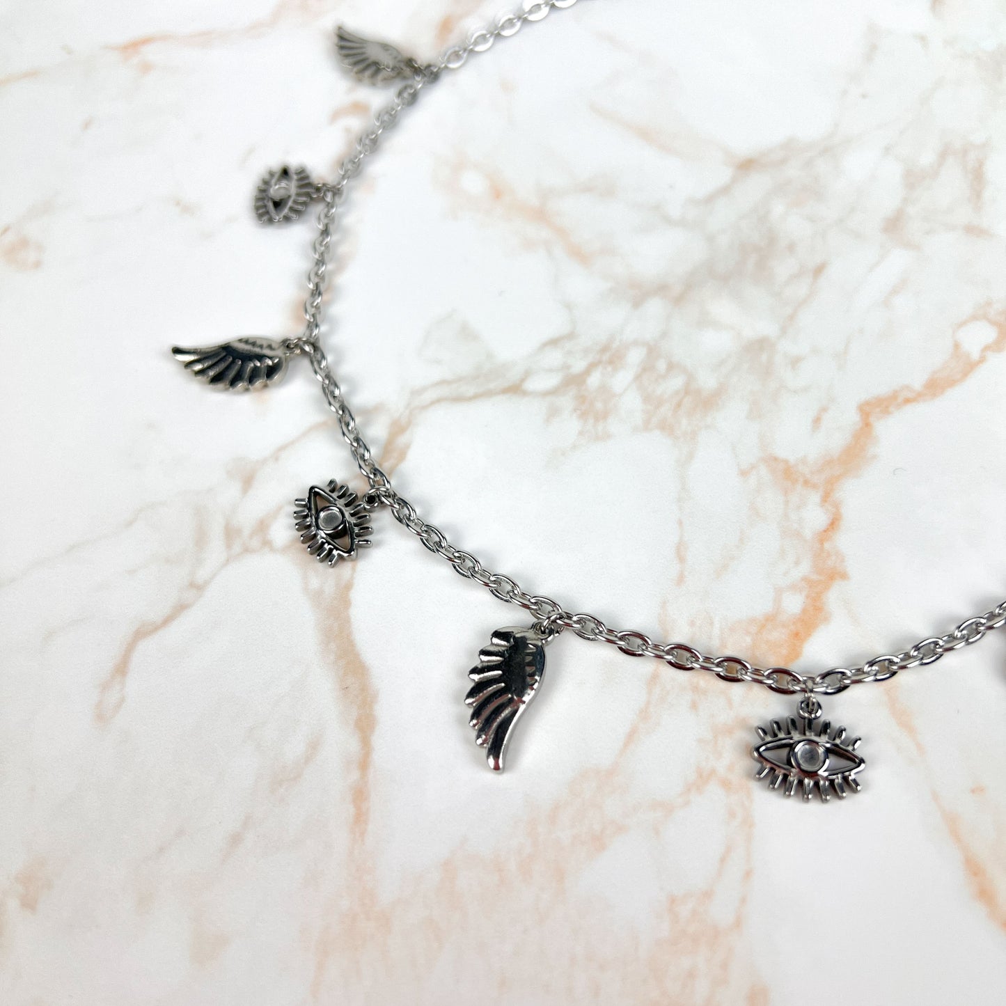 Biblical angel necklace, eyes and wings charms, made of stainless steel Baguette Magick