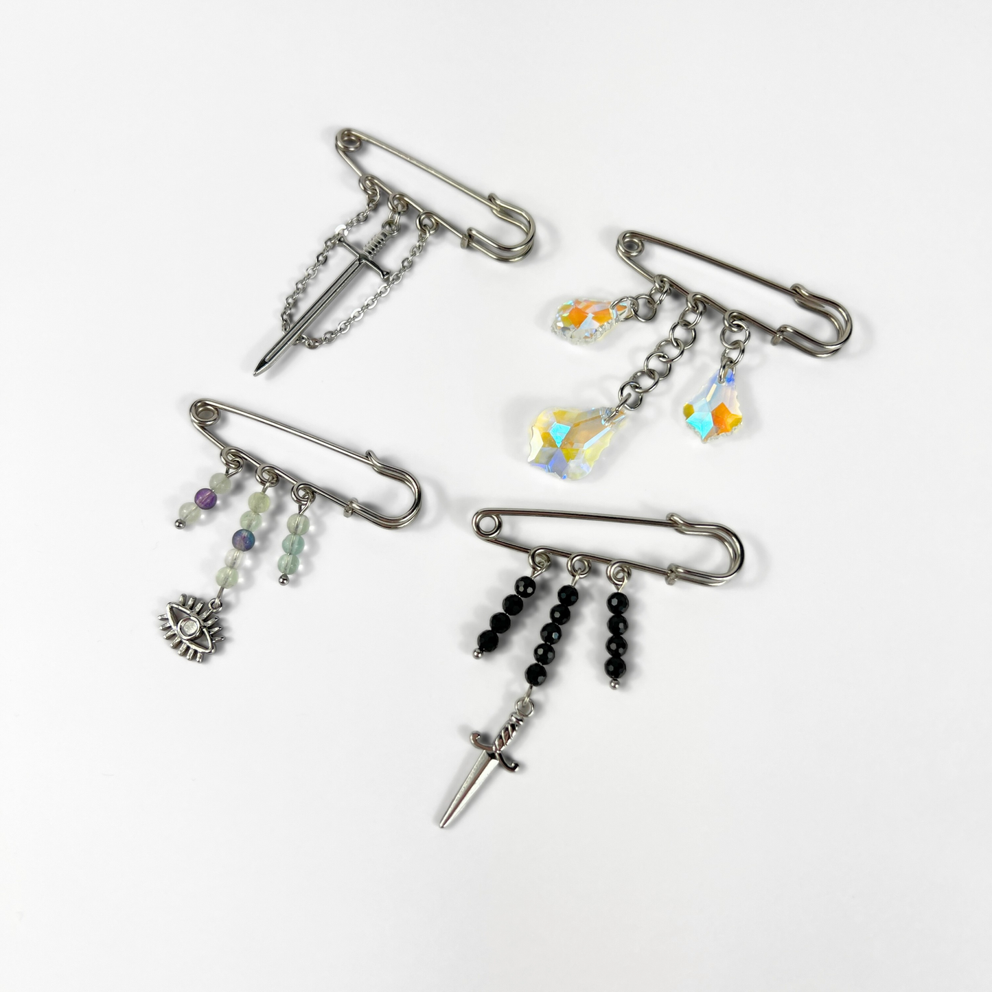 Kilt pin brooch adorned with gemstones, crystal, charms
