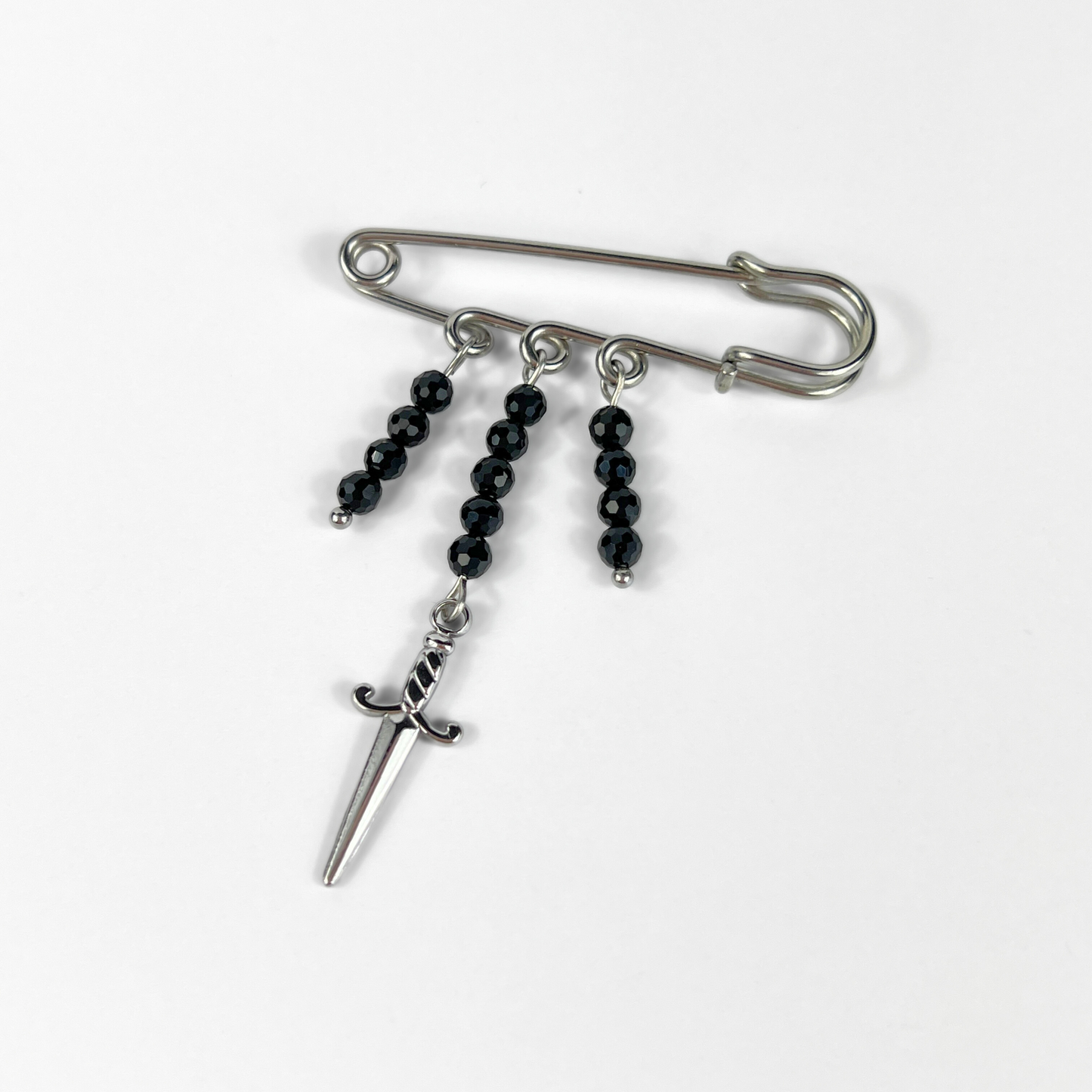 Kilt pin brooch adorned with gemstones, crystal, charms