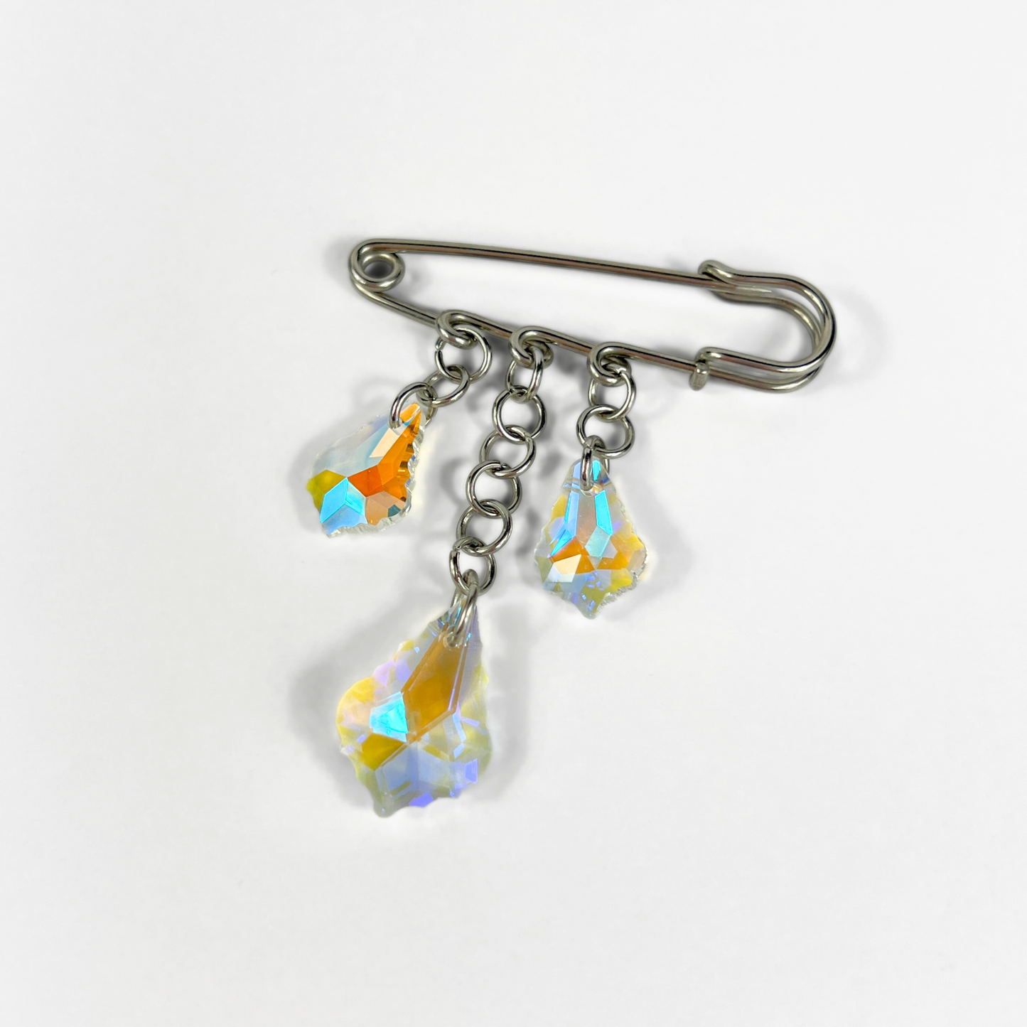 Kilt pin brooch adorned with gemstones, crystal, charms