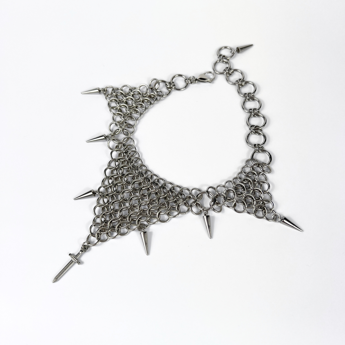 bold chainmail statement choker, with triangle parts, spikes, and dagger, silver tone stainless steel, corporate goth alt medieval fantasy style, necklace for women
