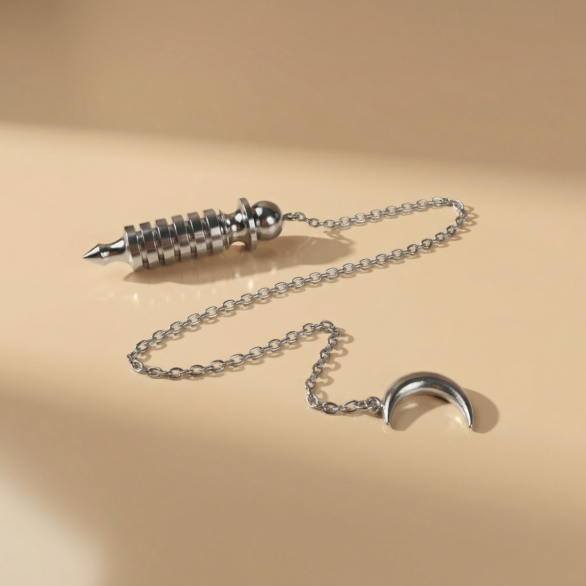 Egyptian Isis metal dowsing pendulum with a chamber and a Moon crescent