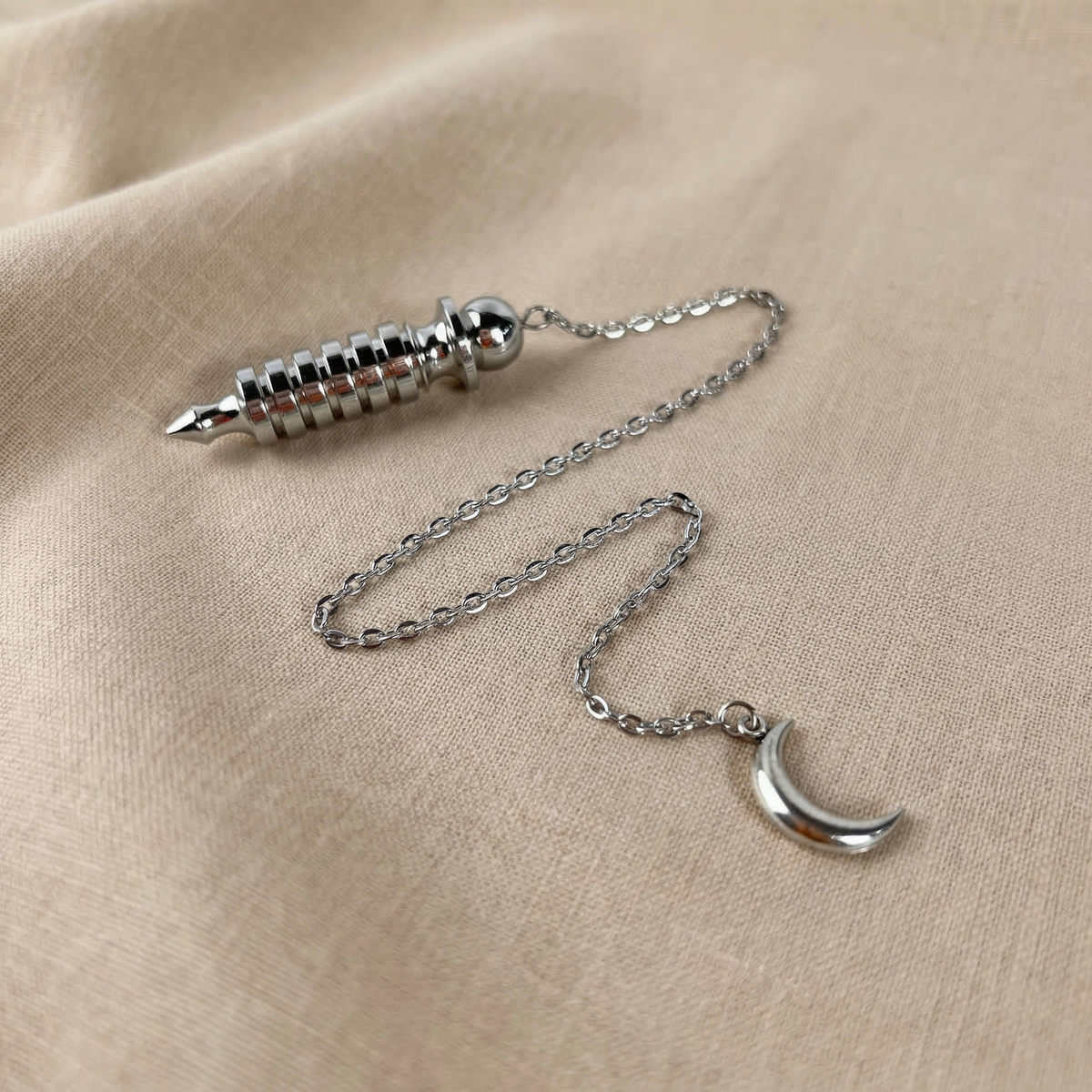 Egyptian Isis metal dowsing pendulum with a chamber and a Moon crescent