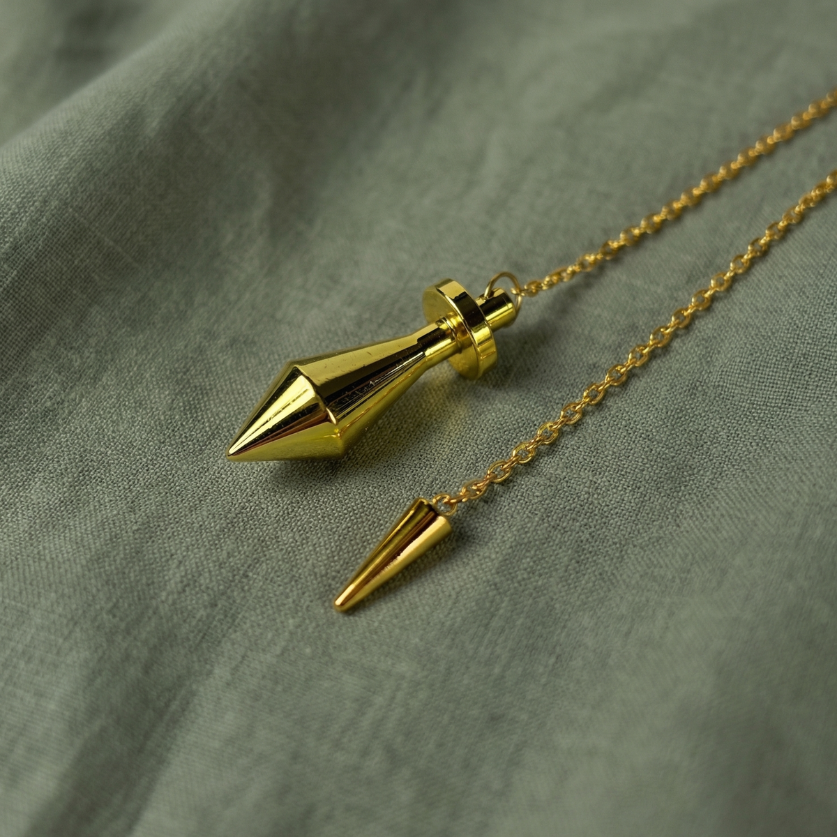 Golden long point dowsing metal pendulum with a spike charm