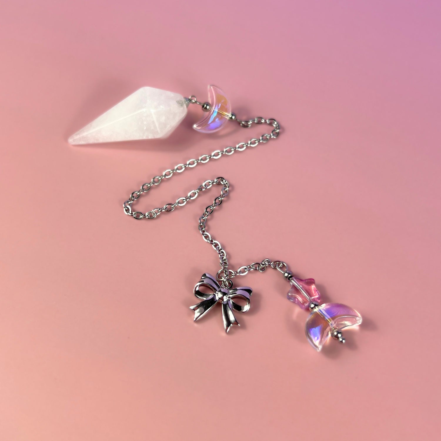 cute and kawai clear quartz dowsing pendulum with glass moons, star, and bow charms