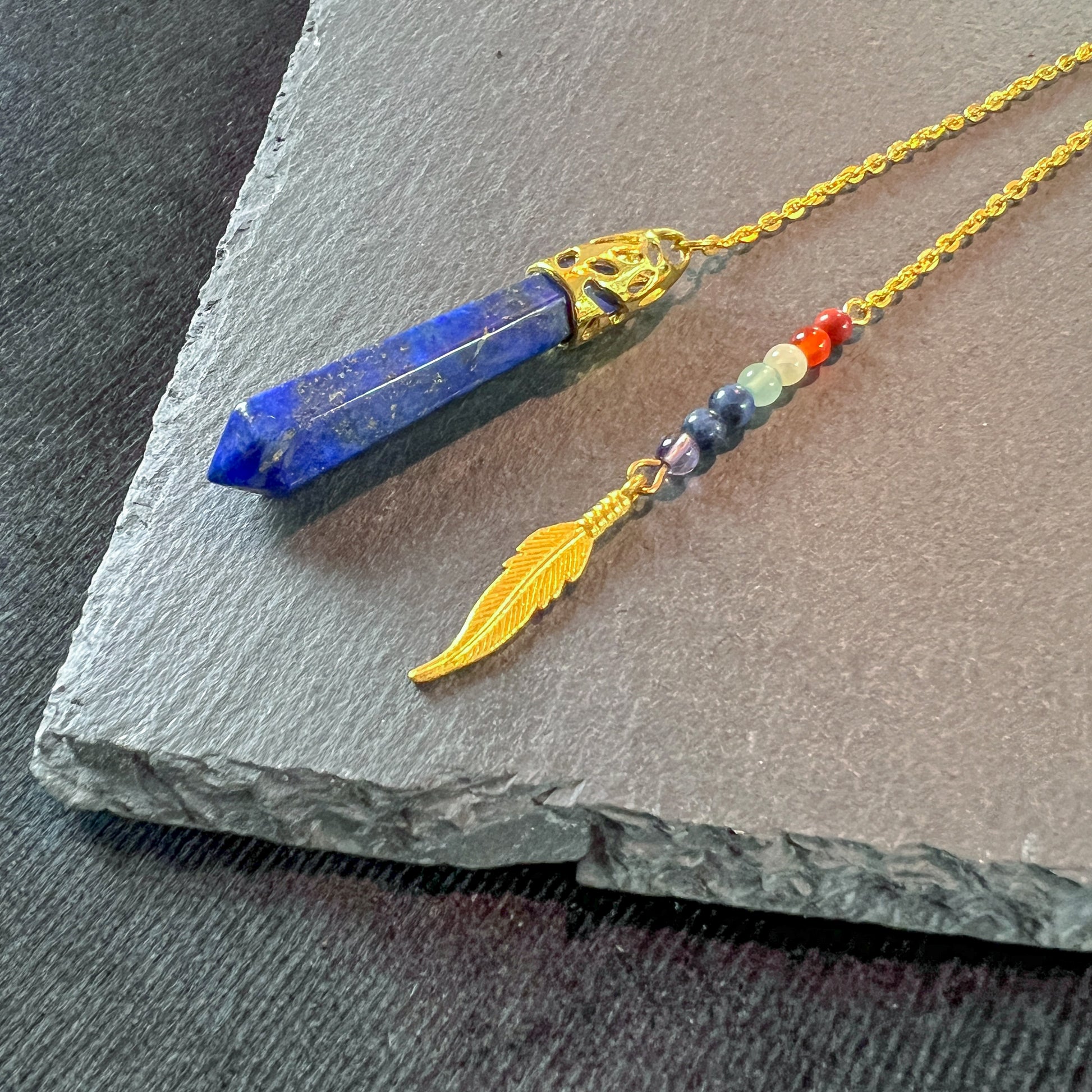 7 chakras lapis lazuli golden pendulum with a feather charm Baguette Magick