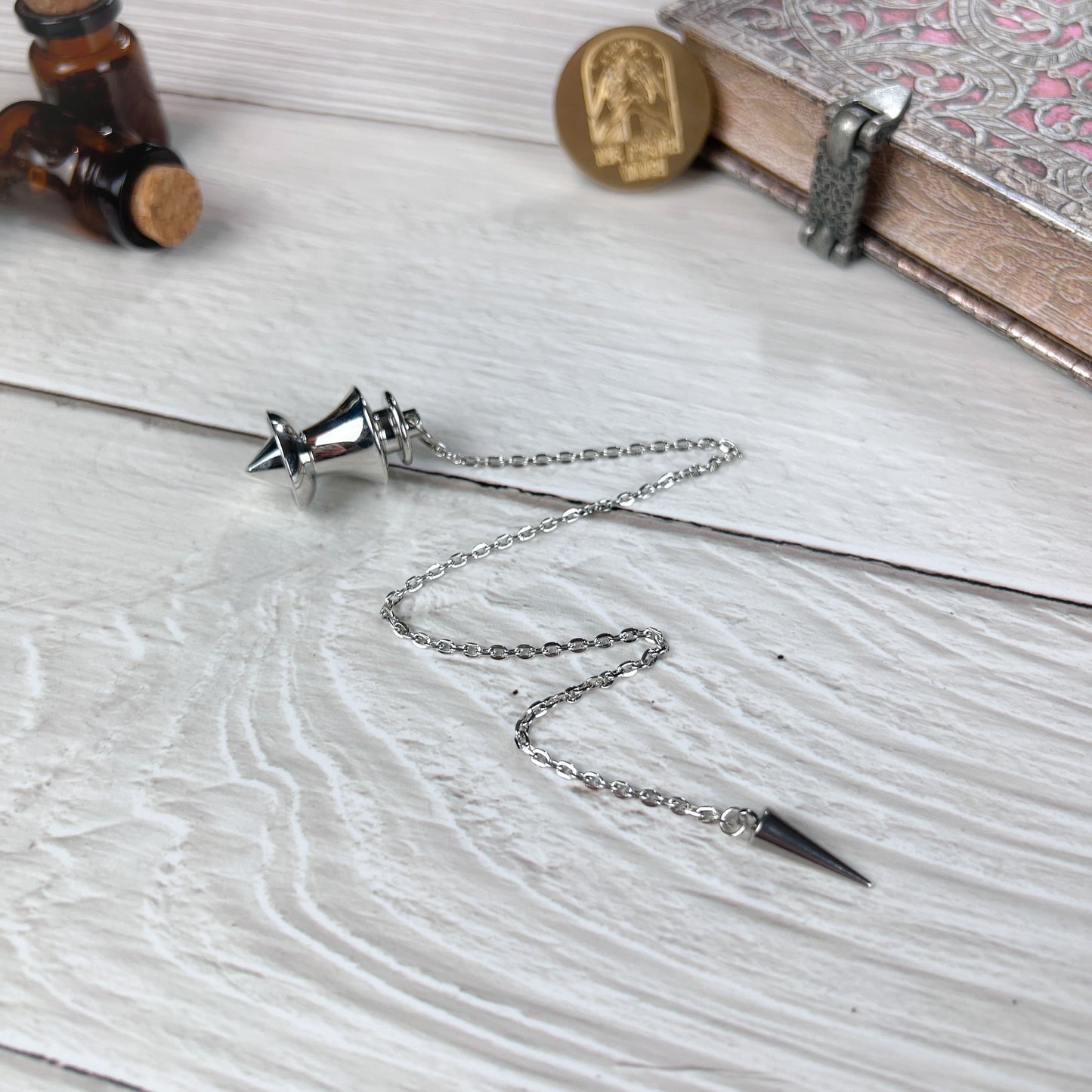 Point and dome dowsing metal pendulum with a spike charm Baguette Magick