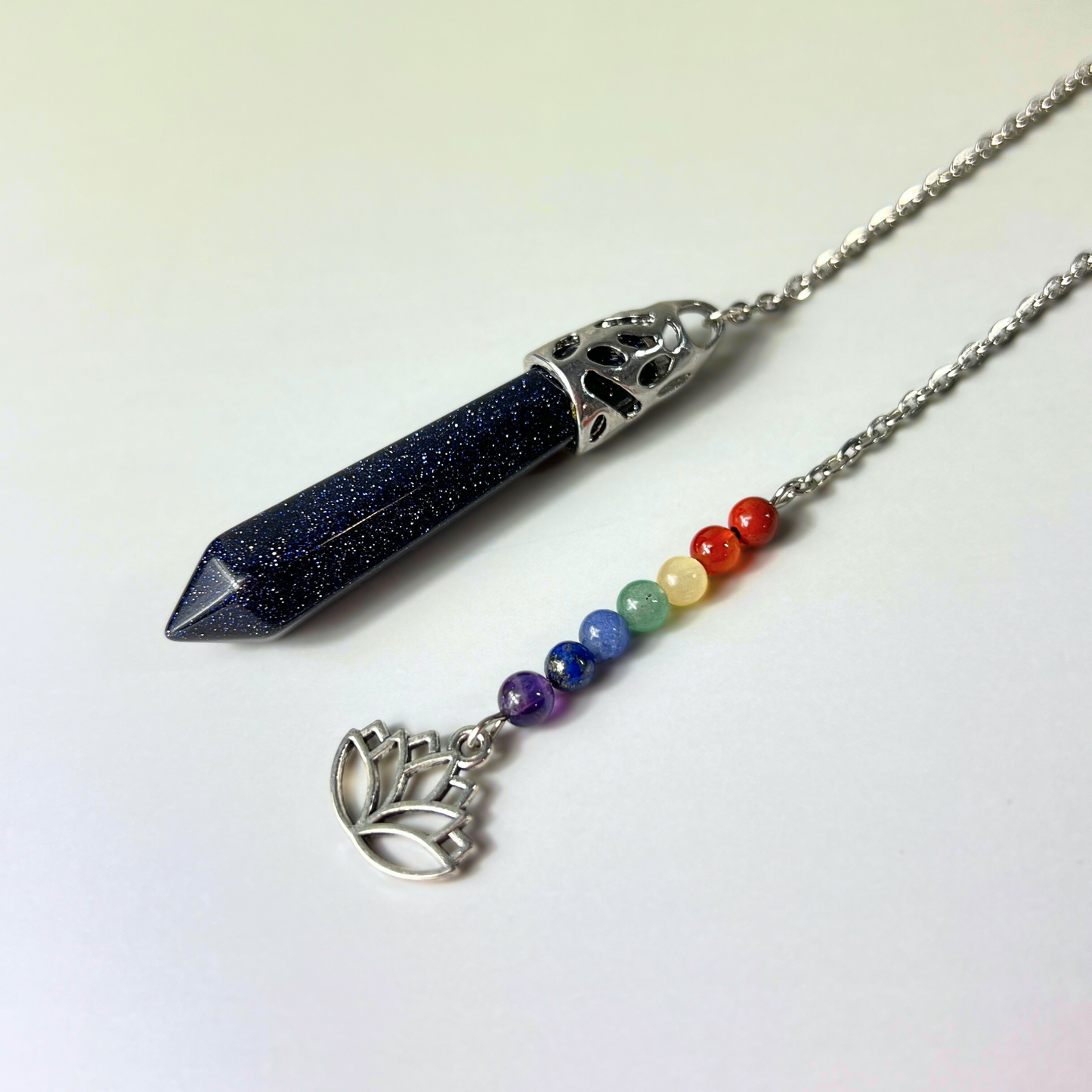 7 chakras blue sandstone pendulum with a lotus charm Baguette Magick