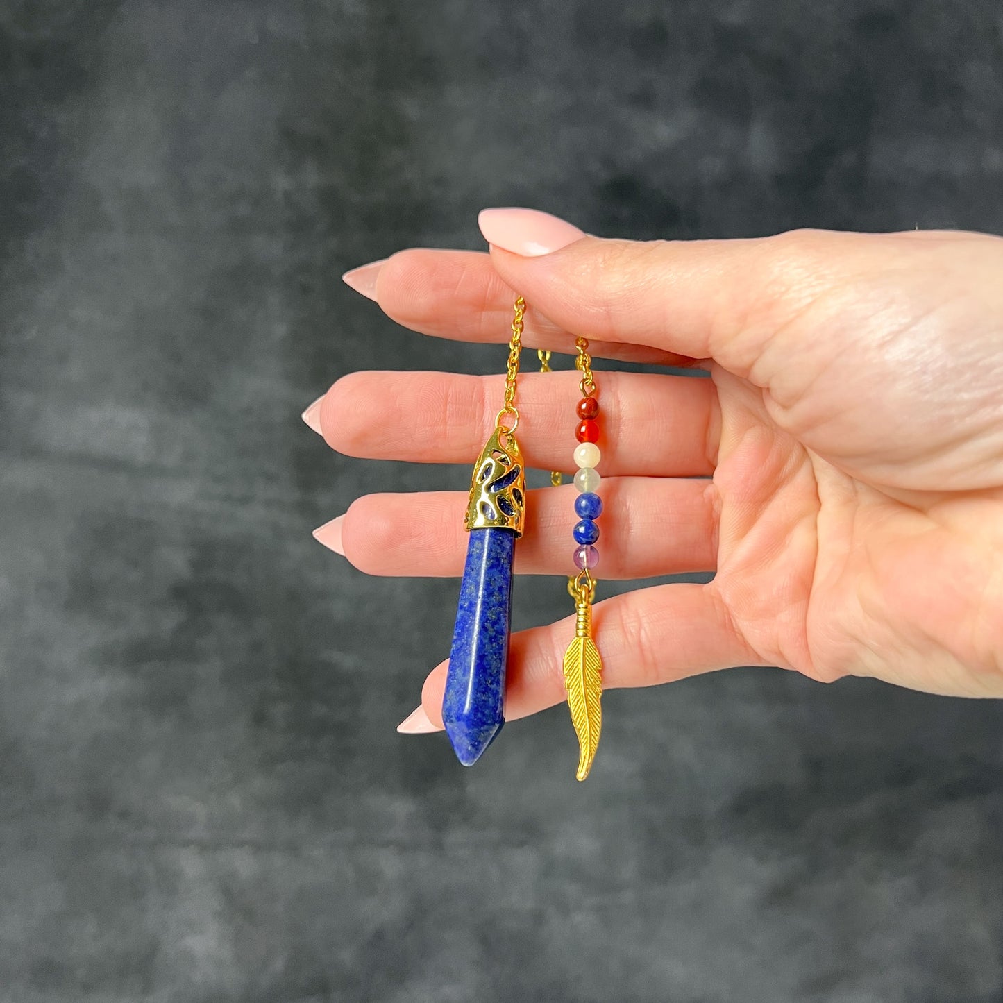 7 chakras lapis lazuli golden pendulum with a feather charm Baguette Magick