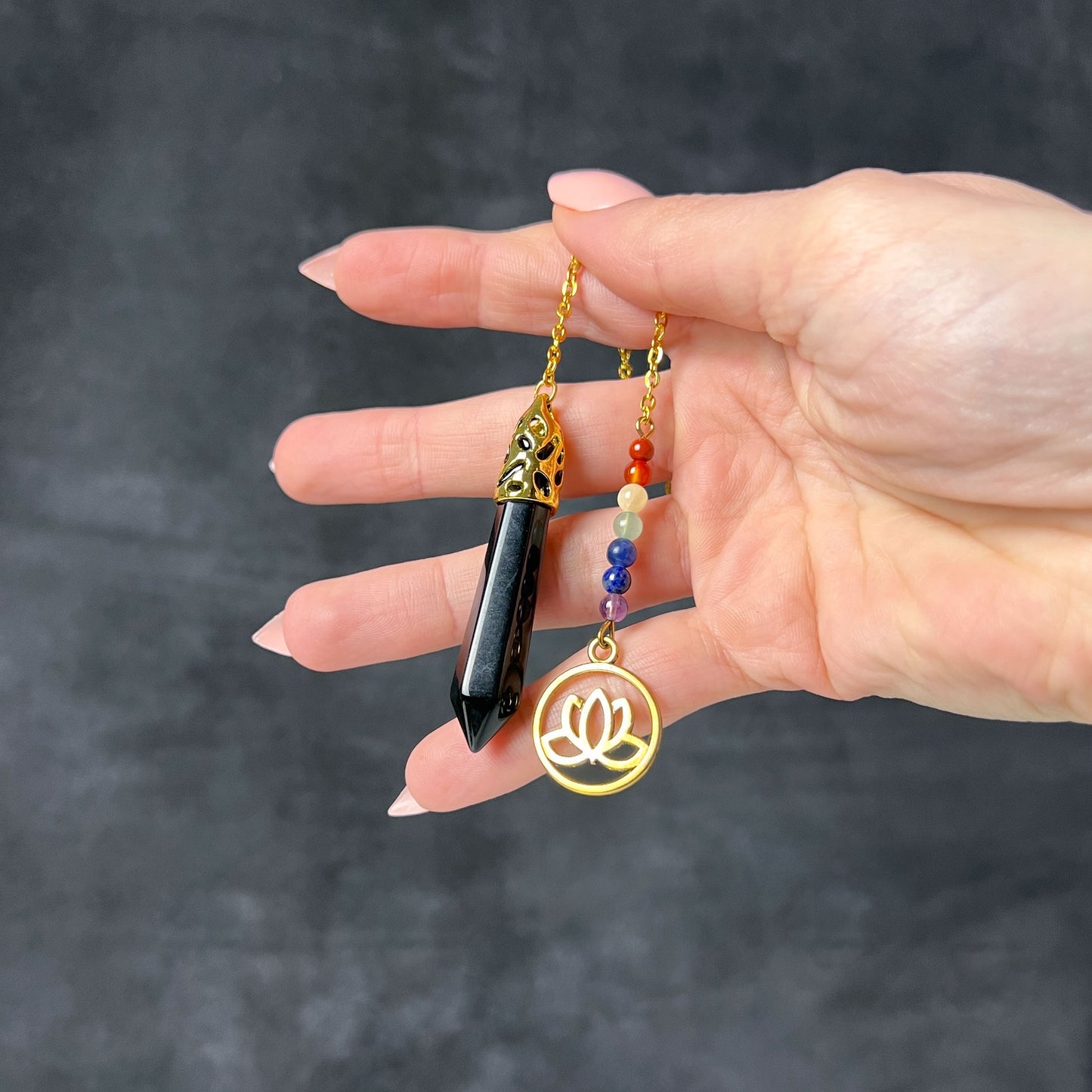 Golden onyx and seven chakras stones pendulum with a lotus charm Baguette Magick