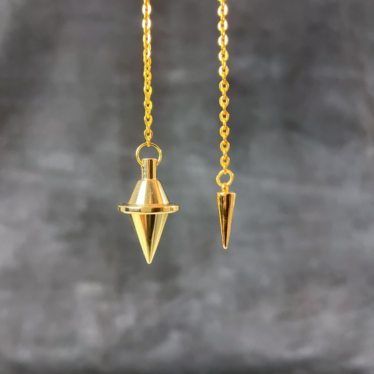 Golden double cone pendulum with a spike charm Baguette Magick