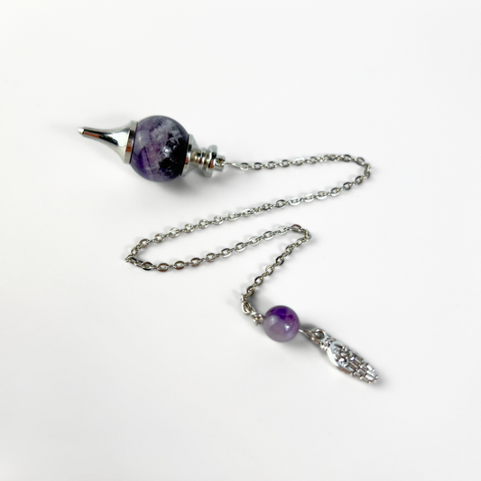 Amethyst and hand holding a lotus Sephoroton dowsing pendulum