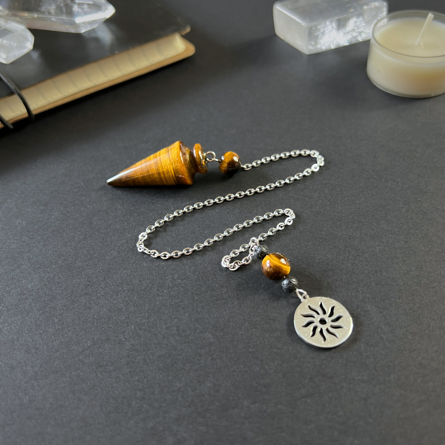 Tiger eye pendulum with a Sun charm