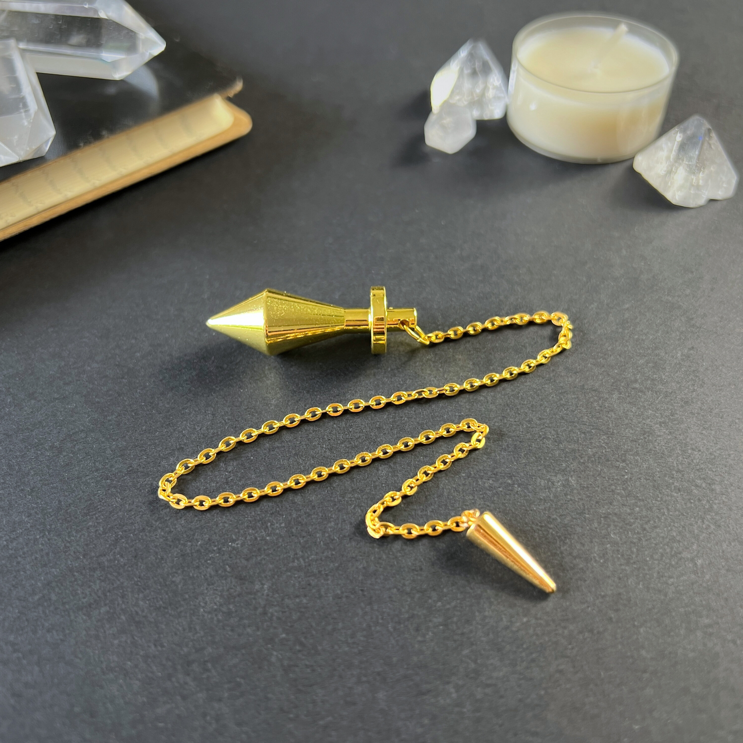 Golden long point dowsing metal pendulum with a spike charm