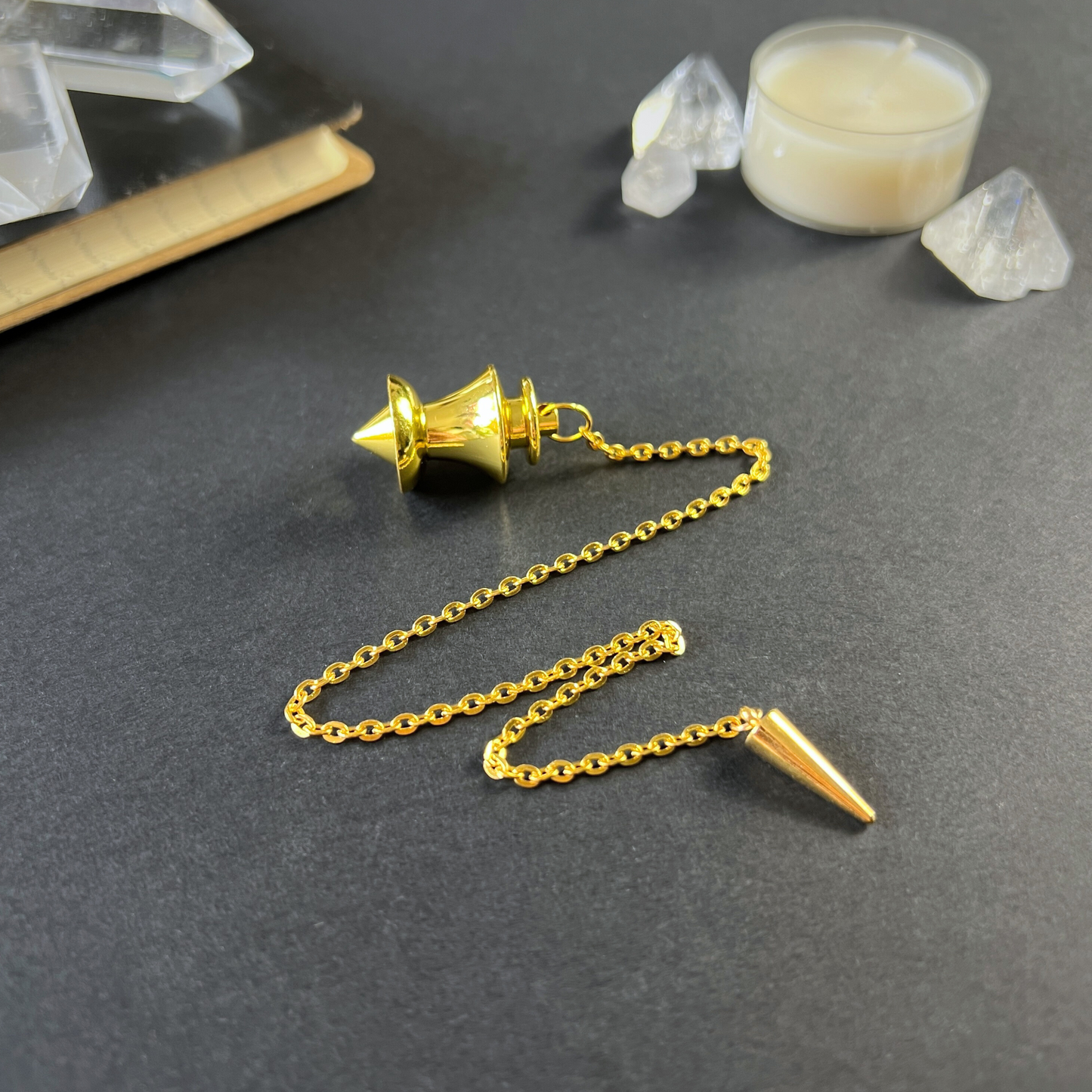 Golden point and dome dowsing metal pendulum with a spike charm