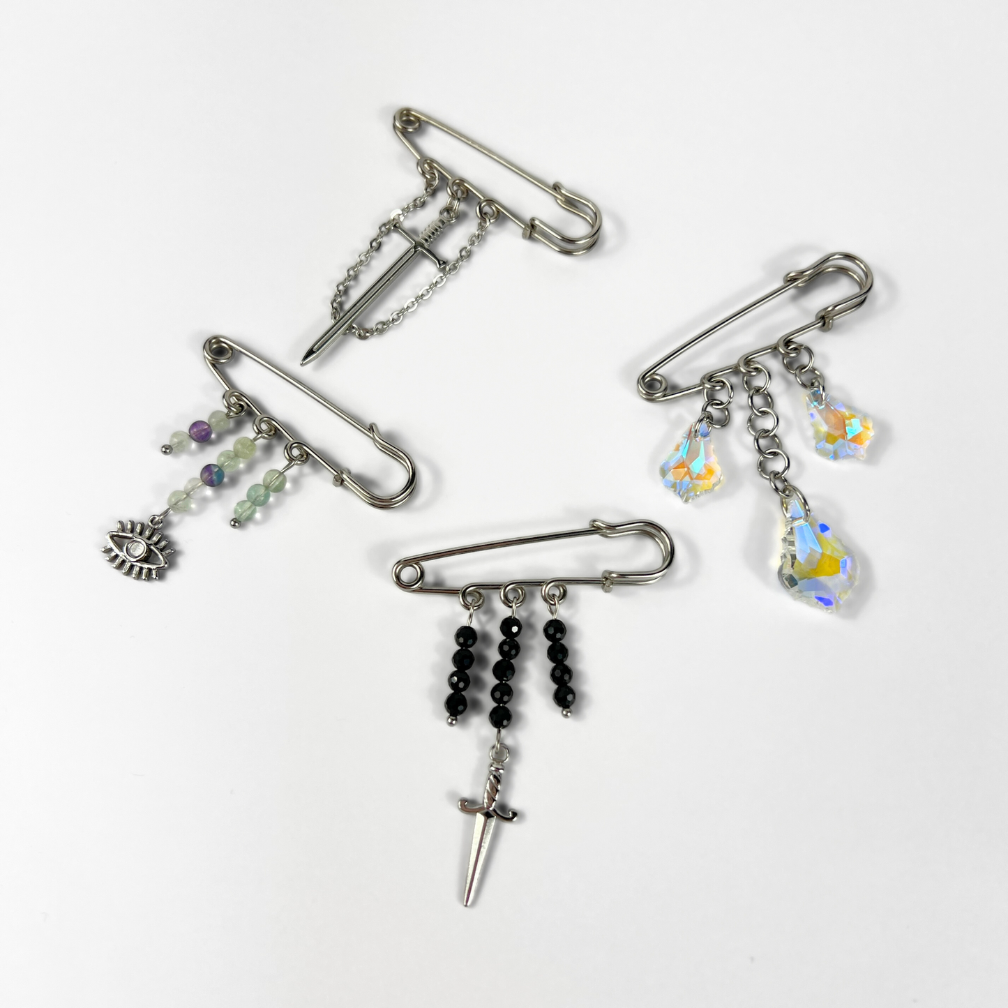 Kilt pin brooch adorned with gemstones, crystal, charms