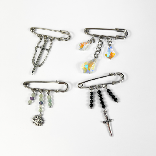Kilt pin brooch adorned with gemstones, crystal, charms