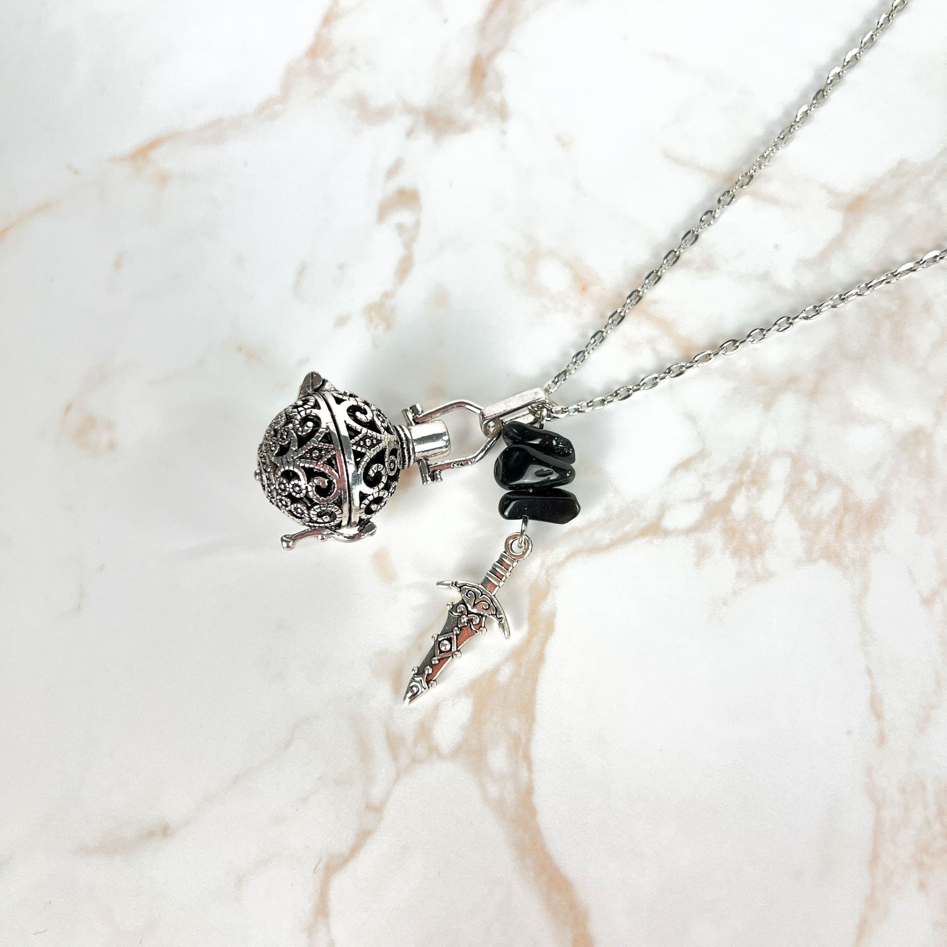 Onyx locket necklace with obsidian beads and a dagger charm Baguette Magick