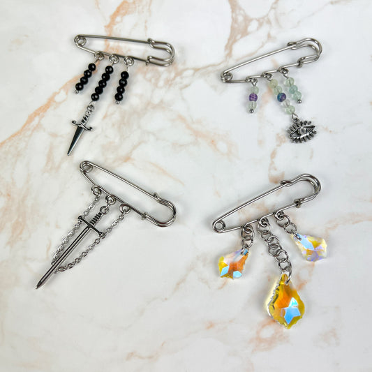 Kilt pin brooch adorned with gemstones, crystal, charms Baguette Magick